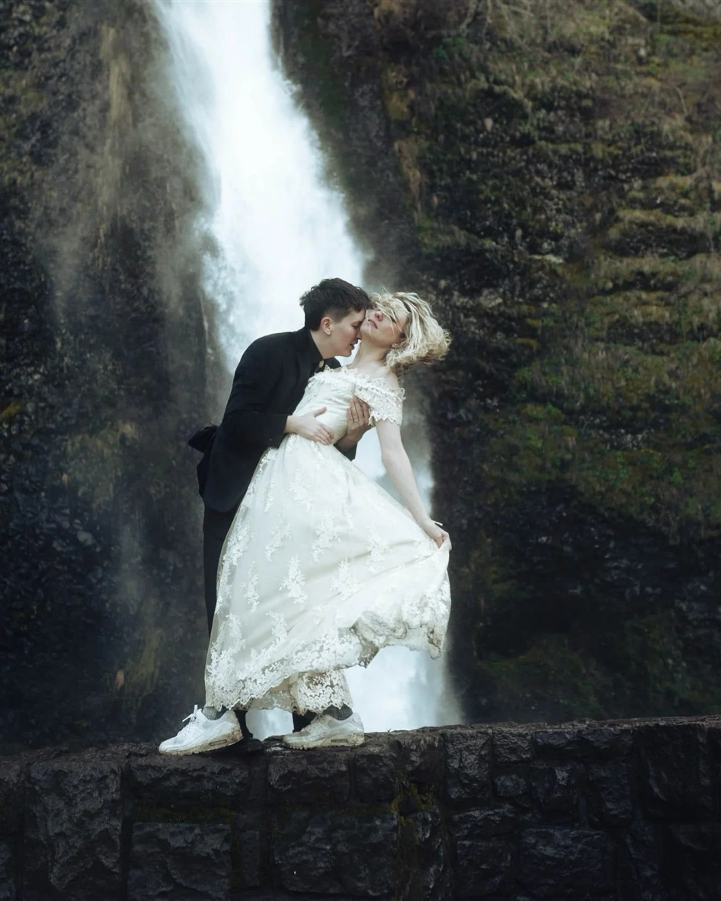 They didn&rsquo;t want perfect. 

They wanted real.
A lace gown. A black suit. White Nikes. A waterfall that didn&rsquo;t care what the forecast said.

This is what it looks like when two people stop performing love and just live in it.
No script. No