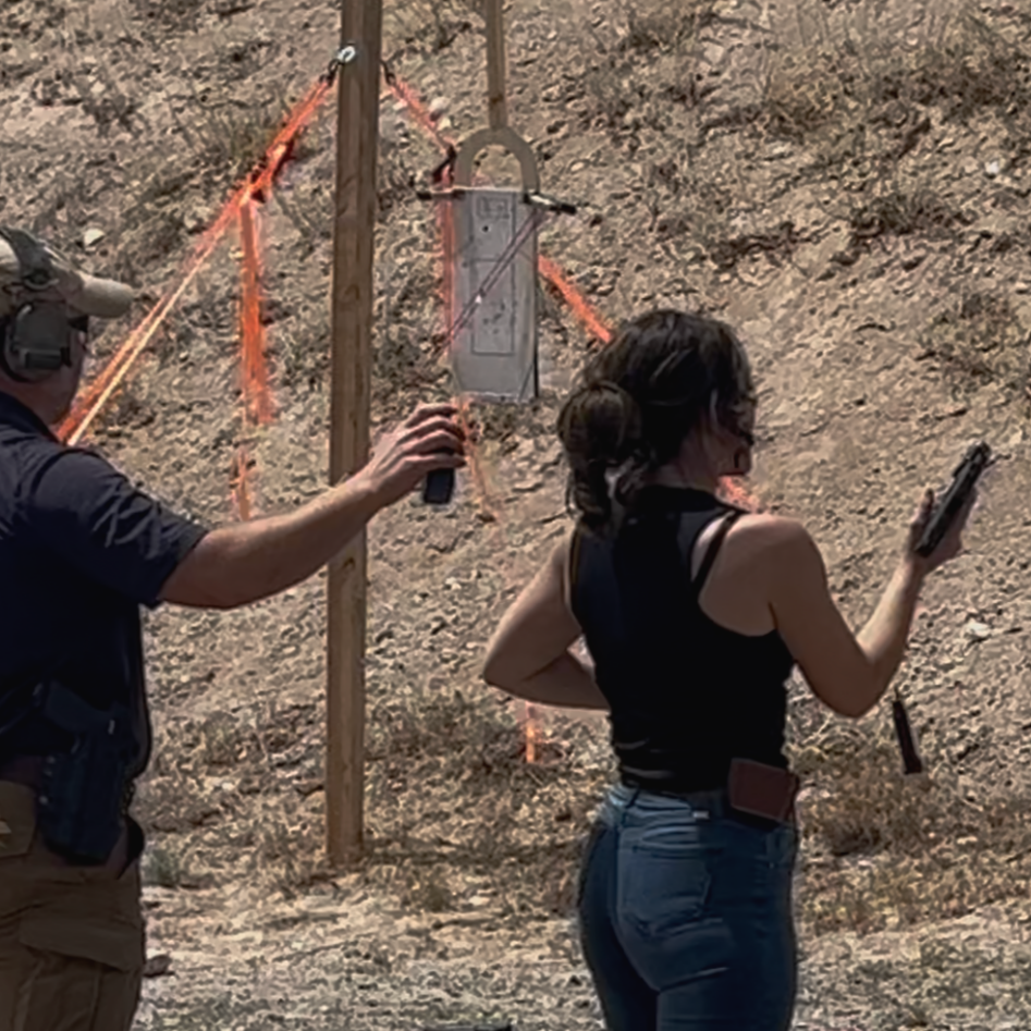 Instructor and student conducting timed reloading drills.