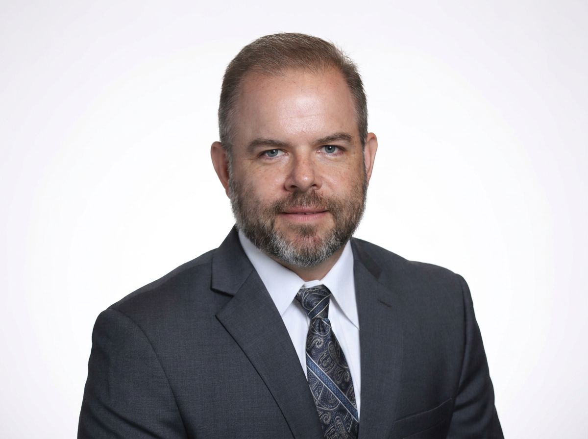 Nick Stake, Owner, in a blue suit.