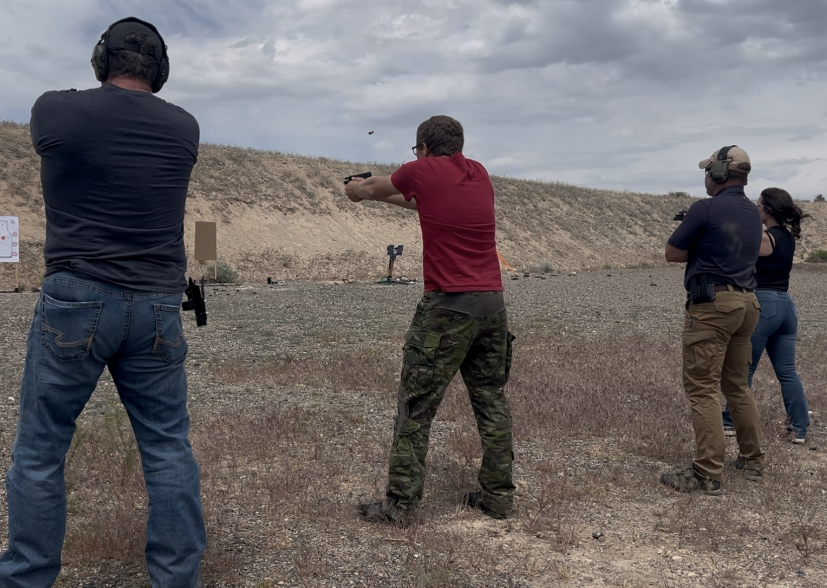 Instructor and students conducting general live-fire training drills with hadnguns.