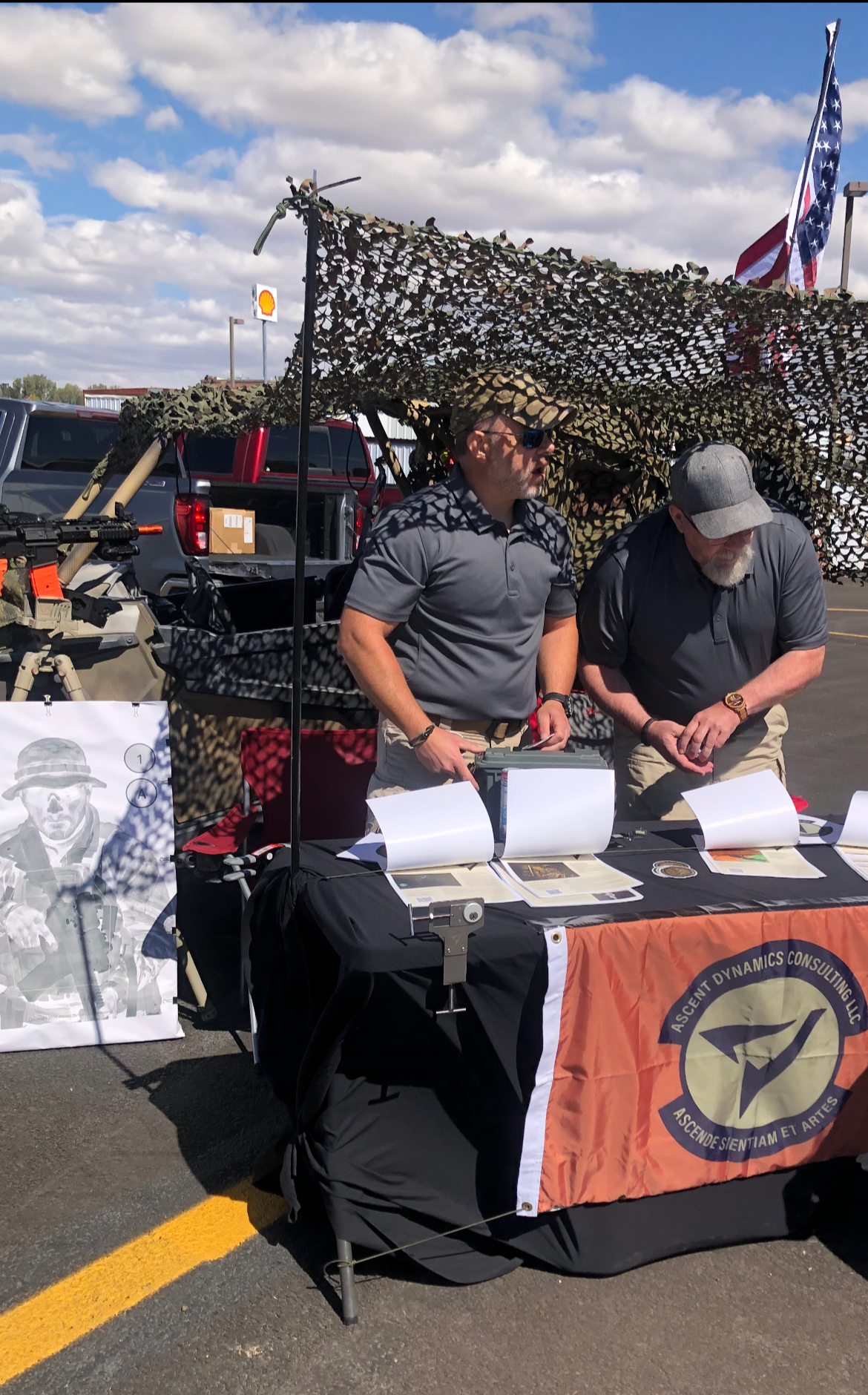 Ascent Dynamics Consulting booth at Skyfair 2026 with lead instructor, training targets, and branded table display.