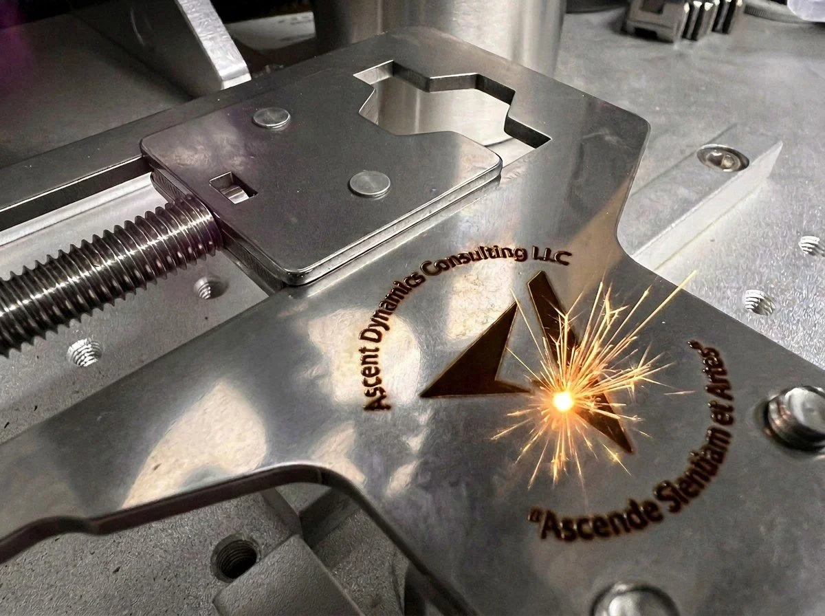 Lock picking fixture being engraved with company logo.