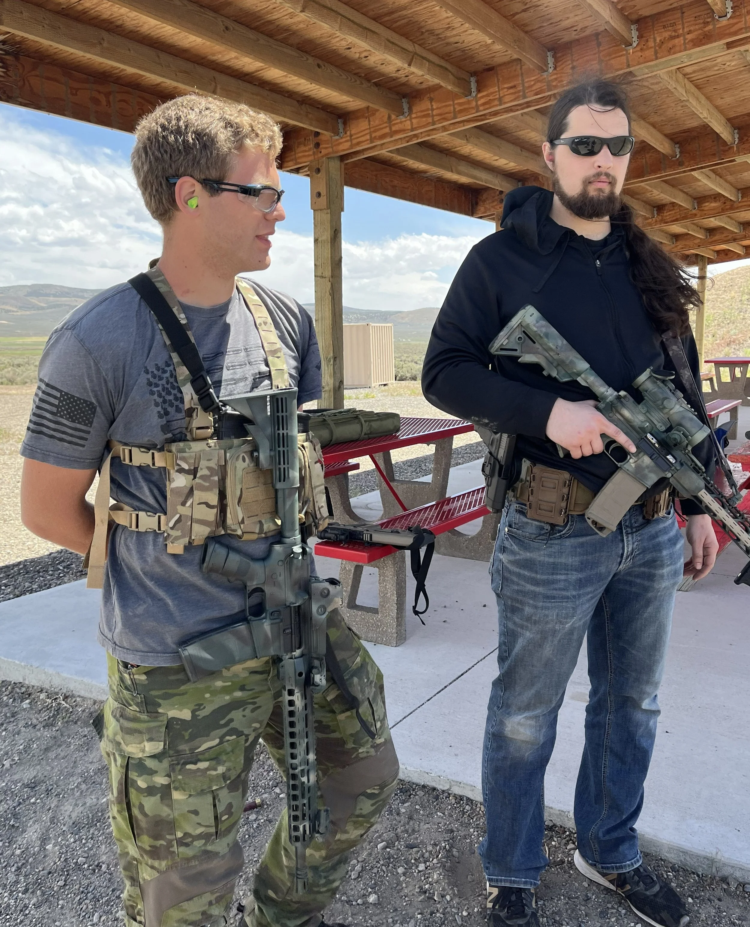 Two student standing in the ready area with carbines slung.