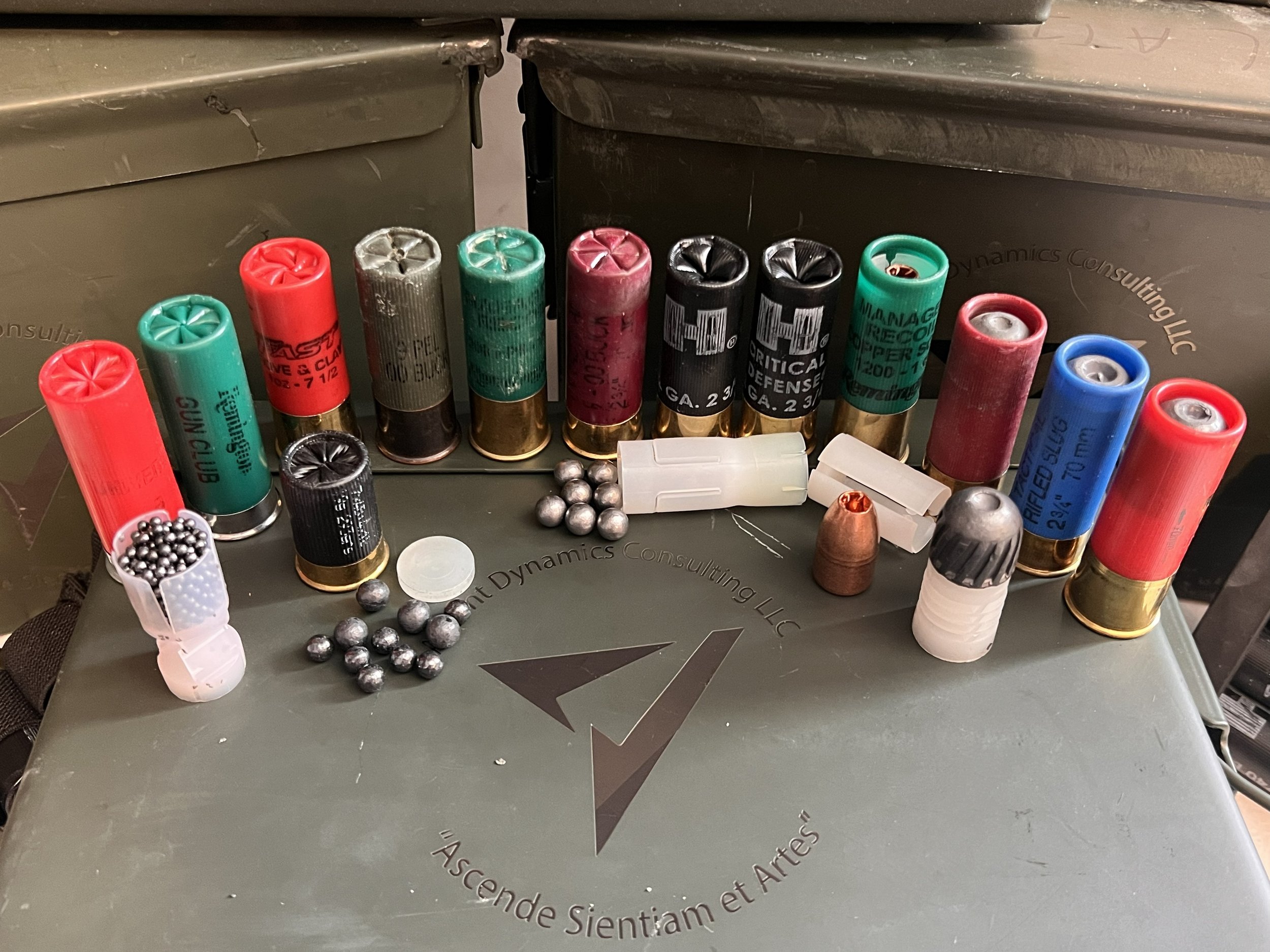 Multiple rounds of shotgun ammunition placed on ammunition can with company logo.