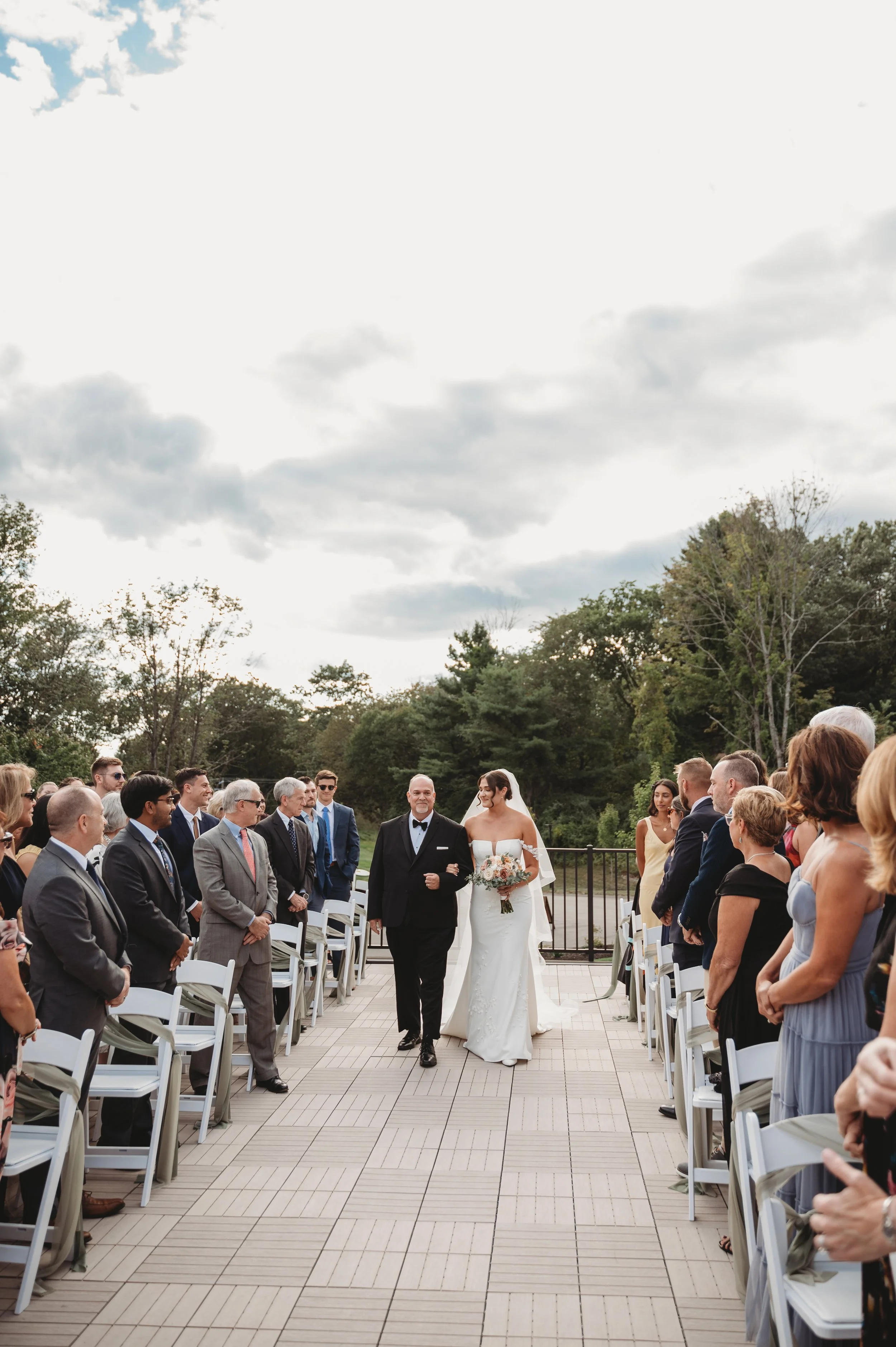 Wedding ceremony located on the Roof Top Deck, facing the aisle during procession. 
