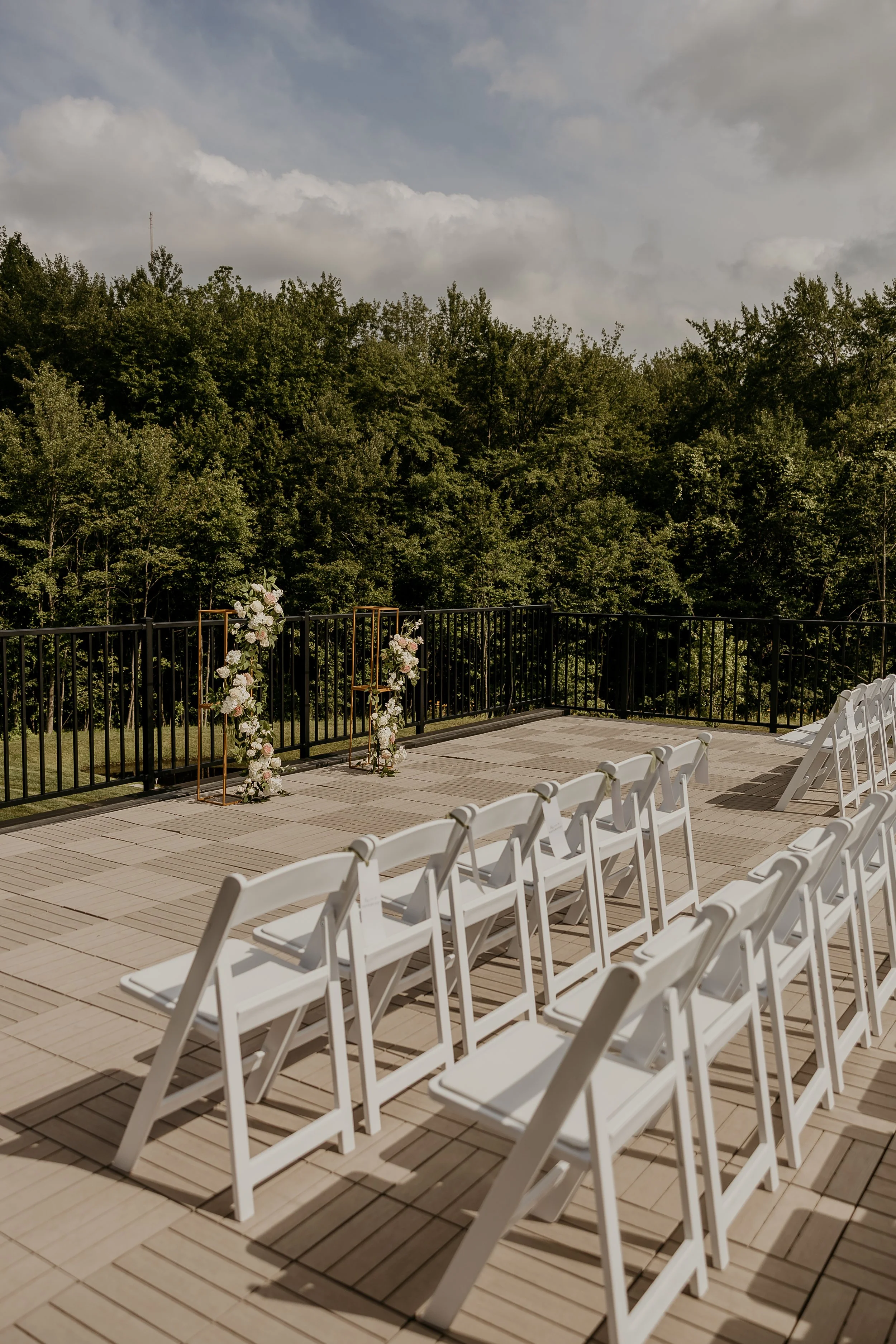 View of wedding ceremony located on Roof Top Deck facing the back woods. 