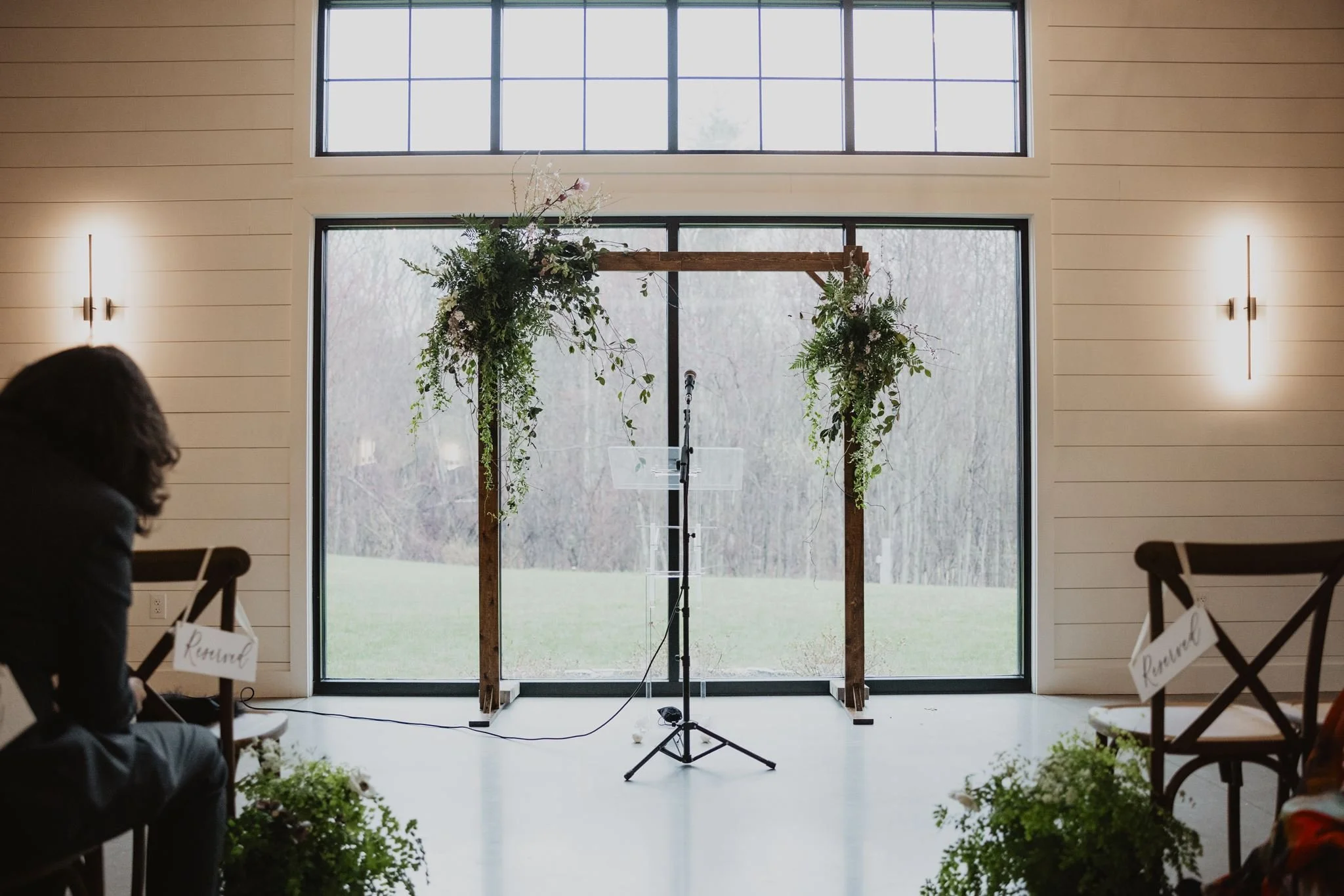 Our indoor arch and acrylic stand paired with client florals.