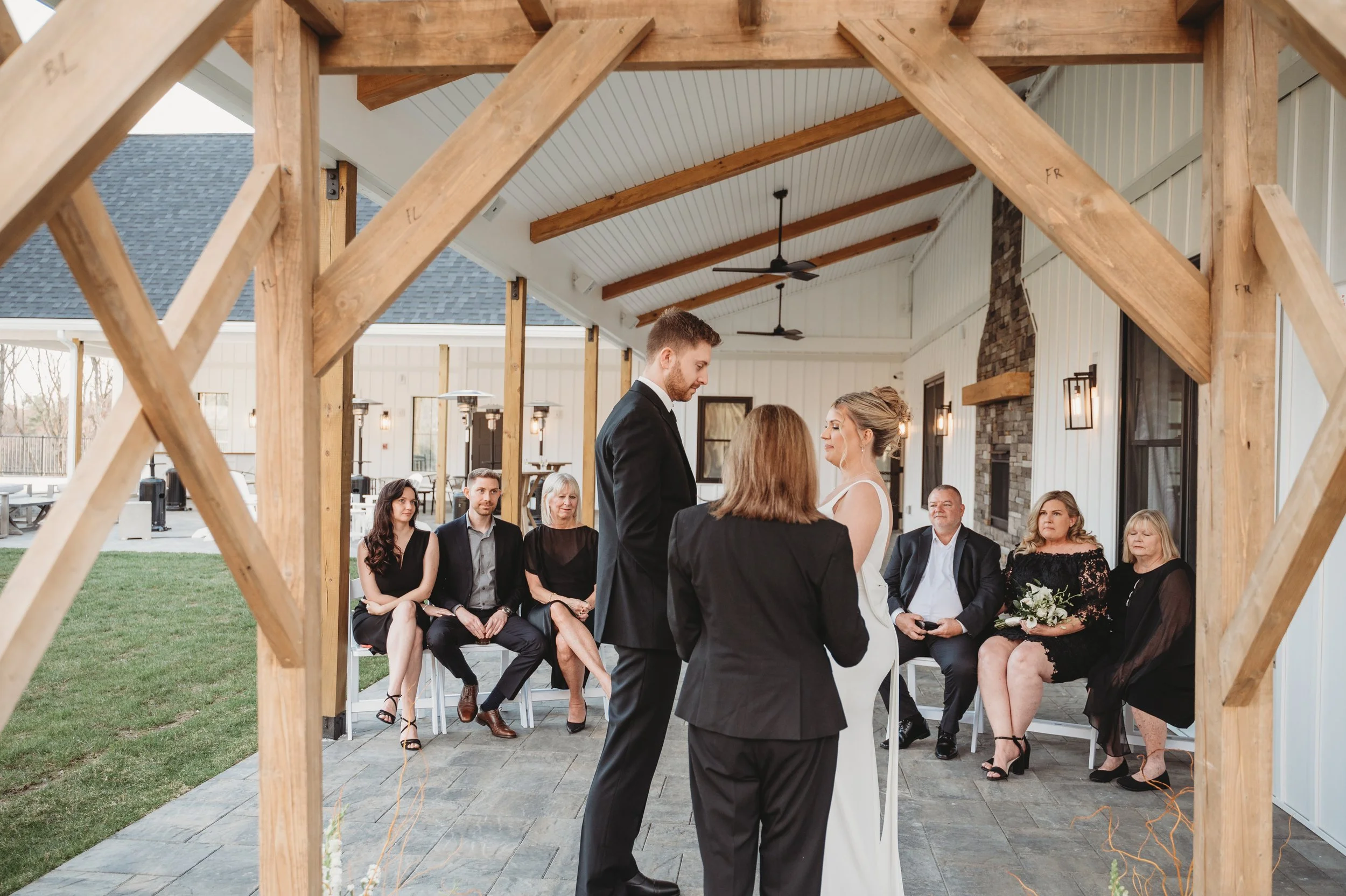 View from behind the arch of intimate wedding ceremony under the Long Covered Porch. 