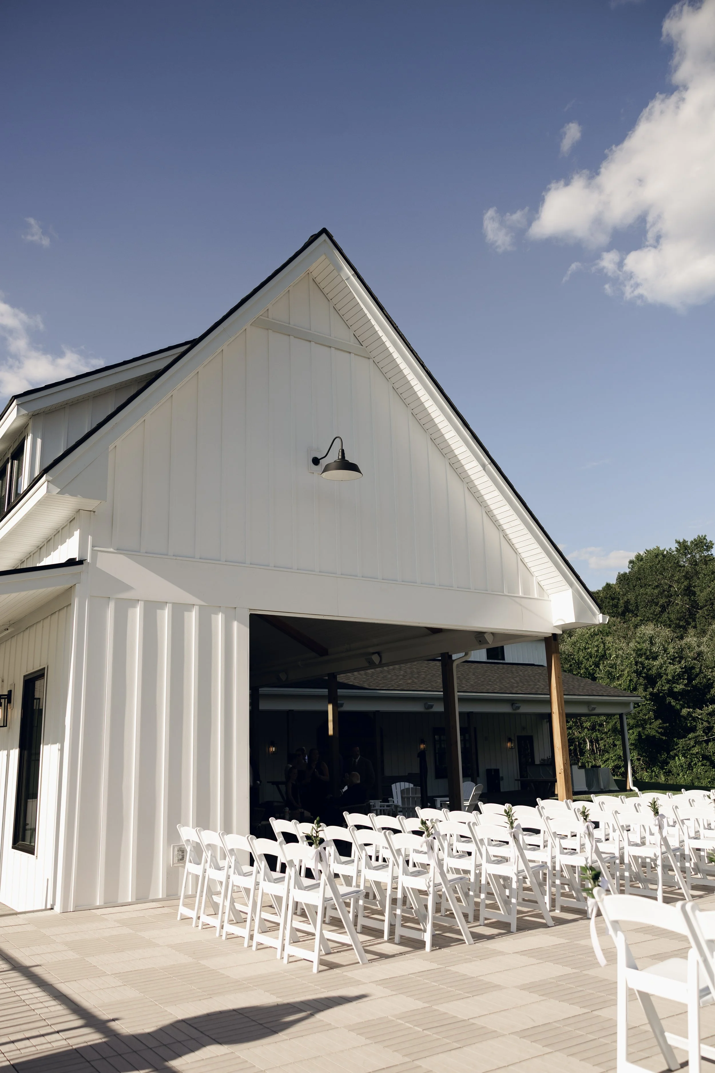 View of pre-ceremony guest seating from back right facing the Covered Breezeway and Middle Lawn. 