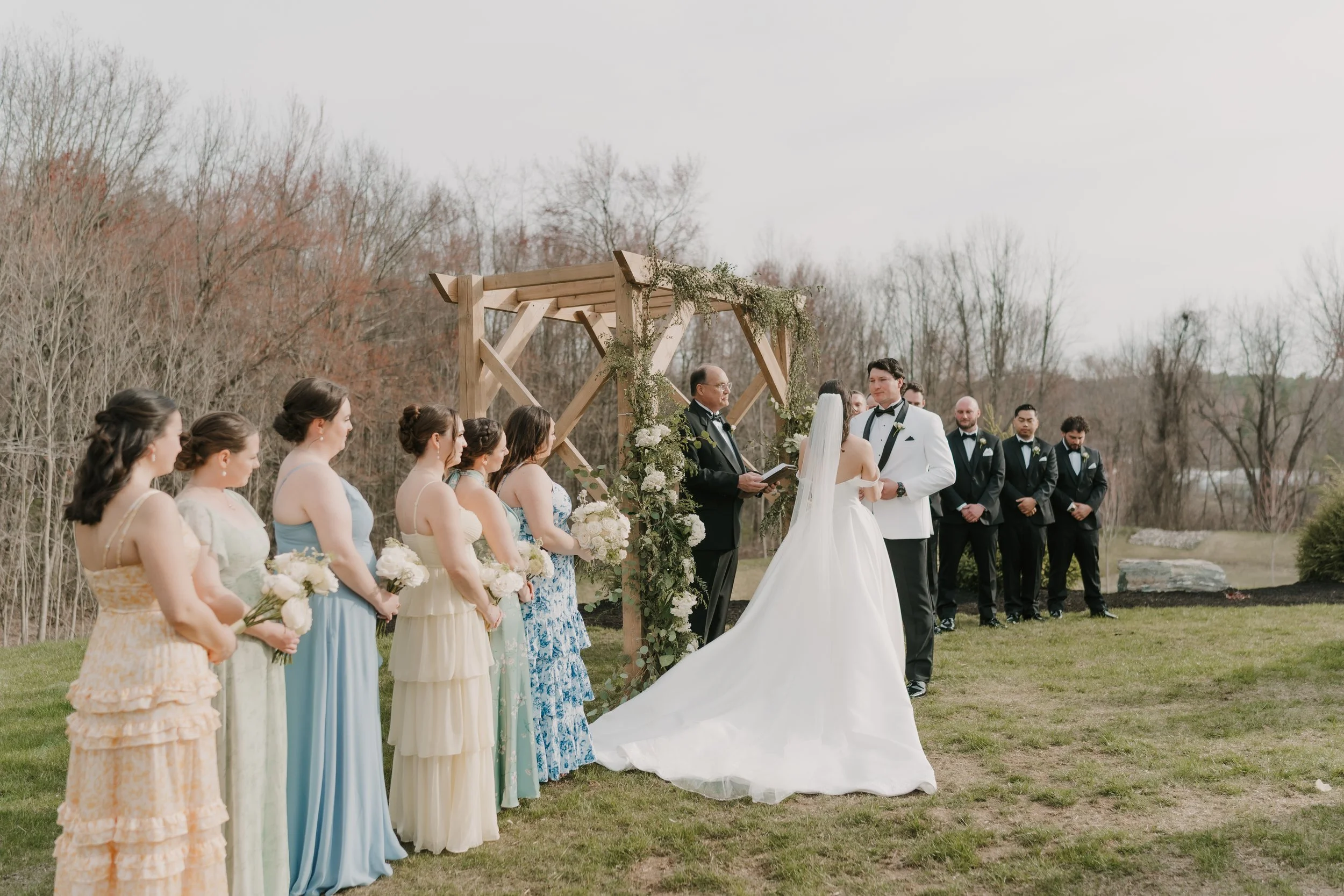 View of wedding ceremony on the Middle Lawn from front left guest seating. 