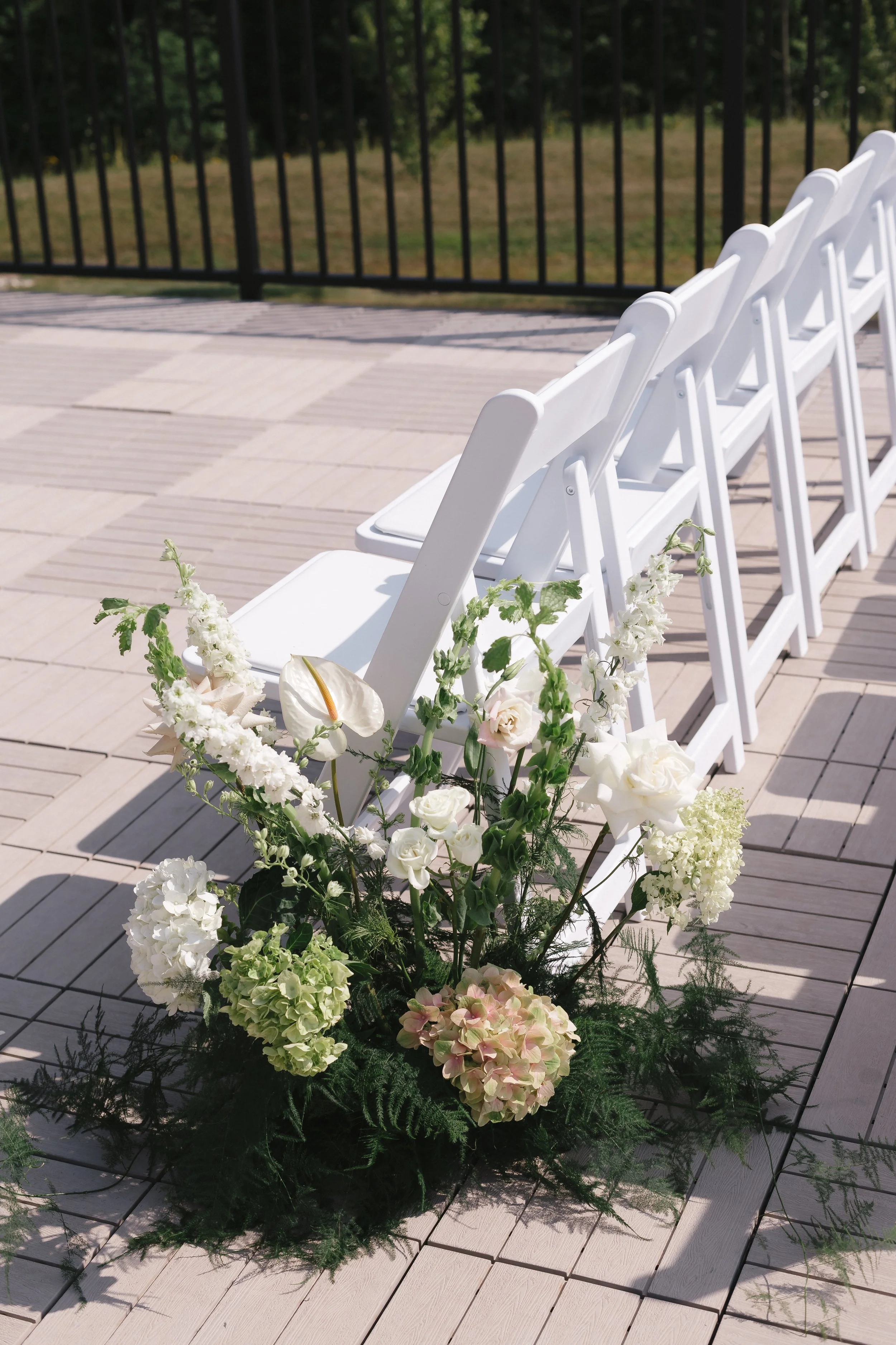 Floral arrangement next to seating for Roof Top Deck ceremony.