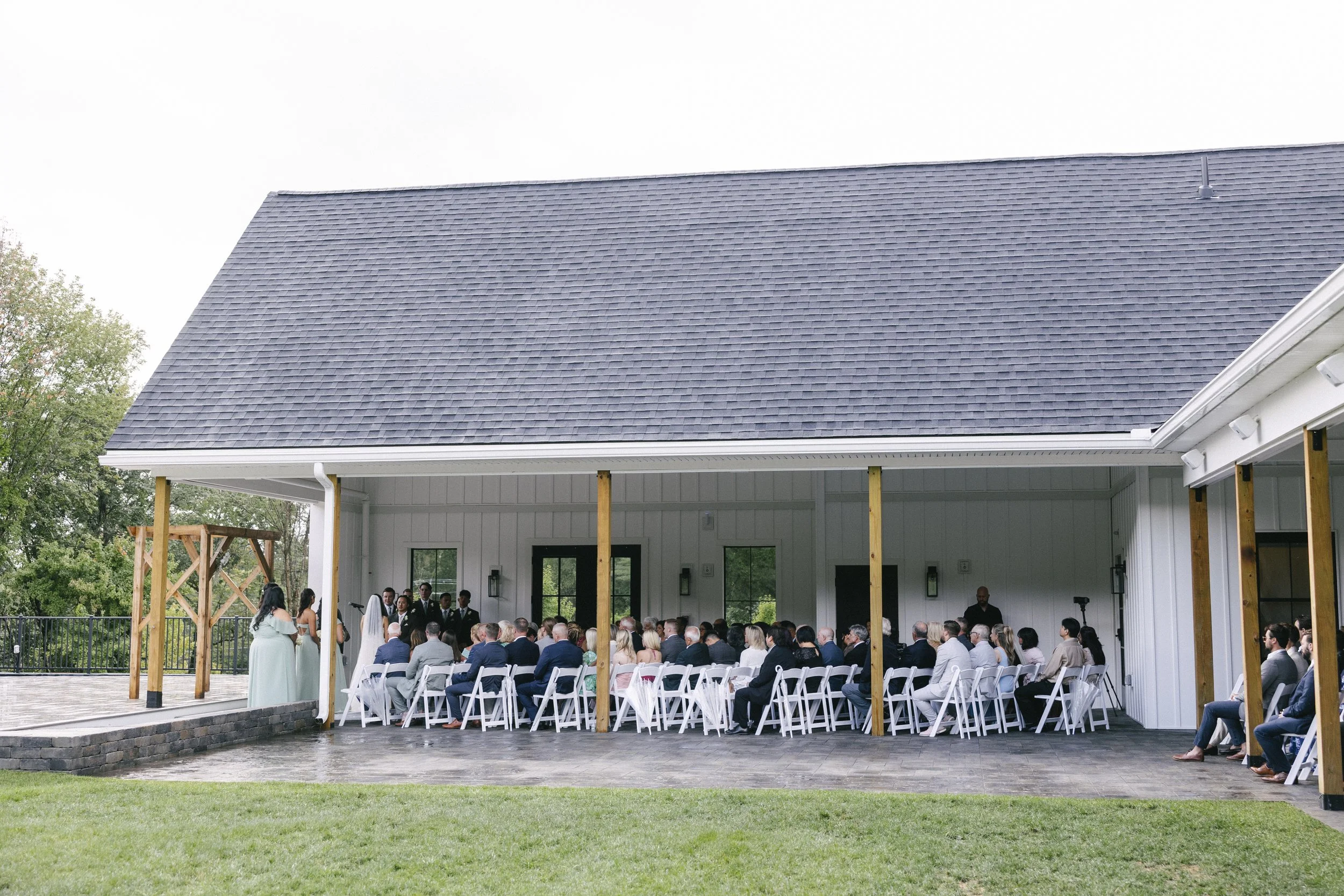 View from the Middle Lawn of wedding ceremony under the Covered Breezeway during inclement weather. 