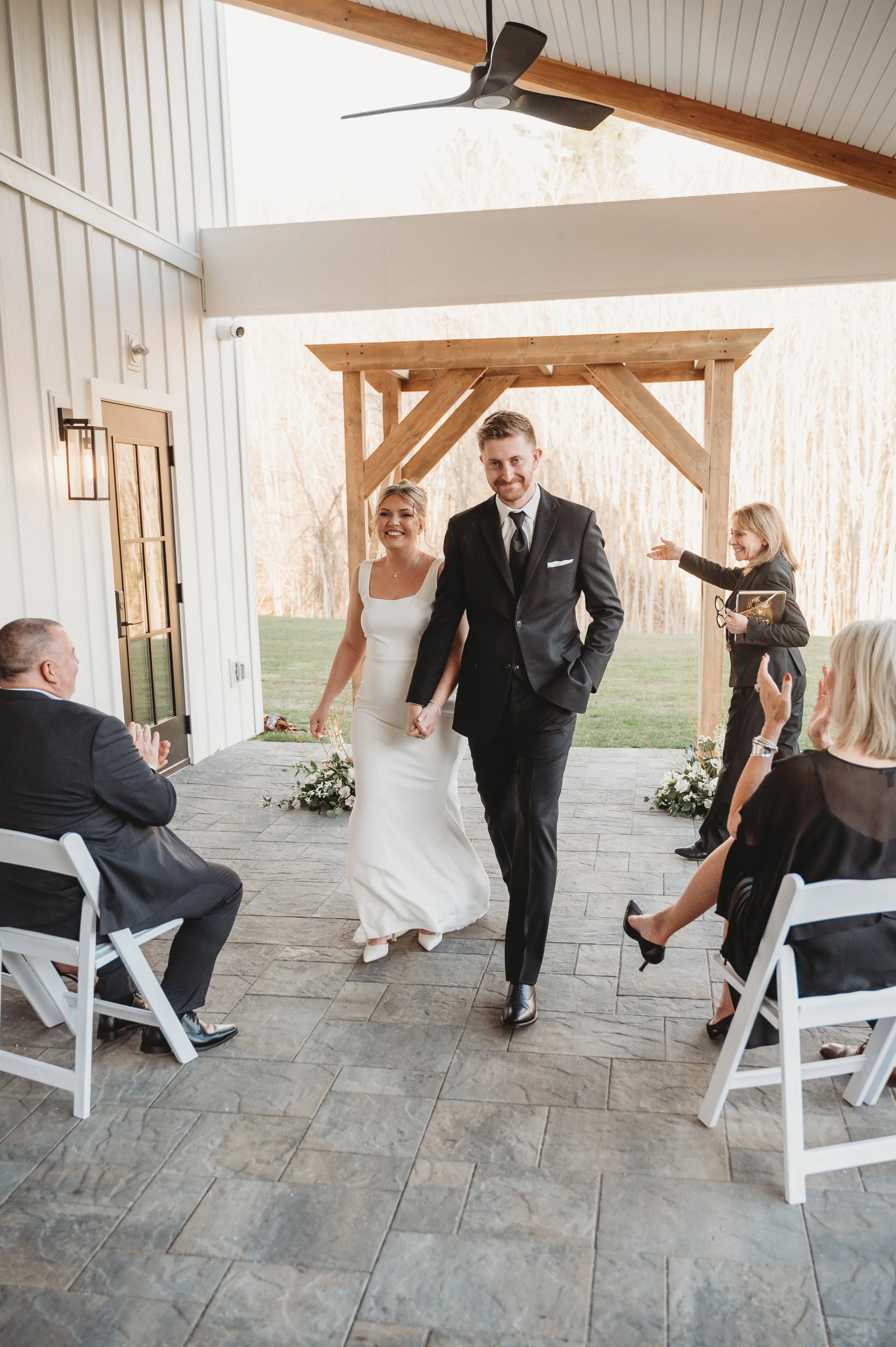 Wedding ceremony located under the Long Covered Porch facing the back woods. 