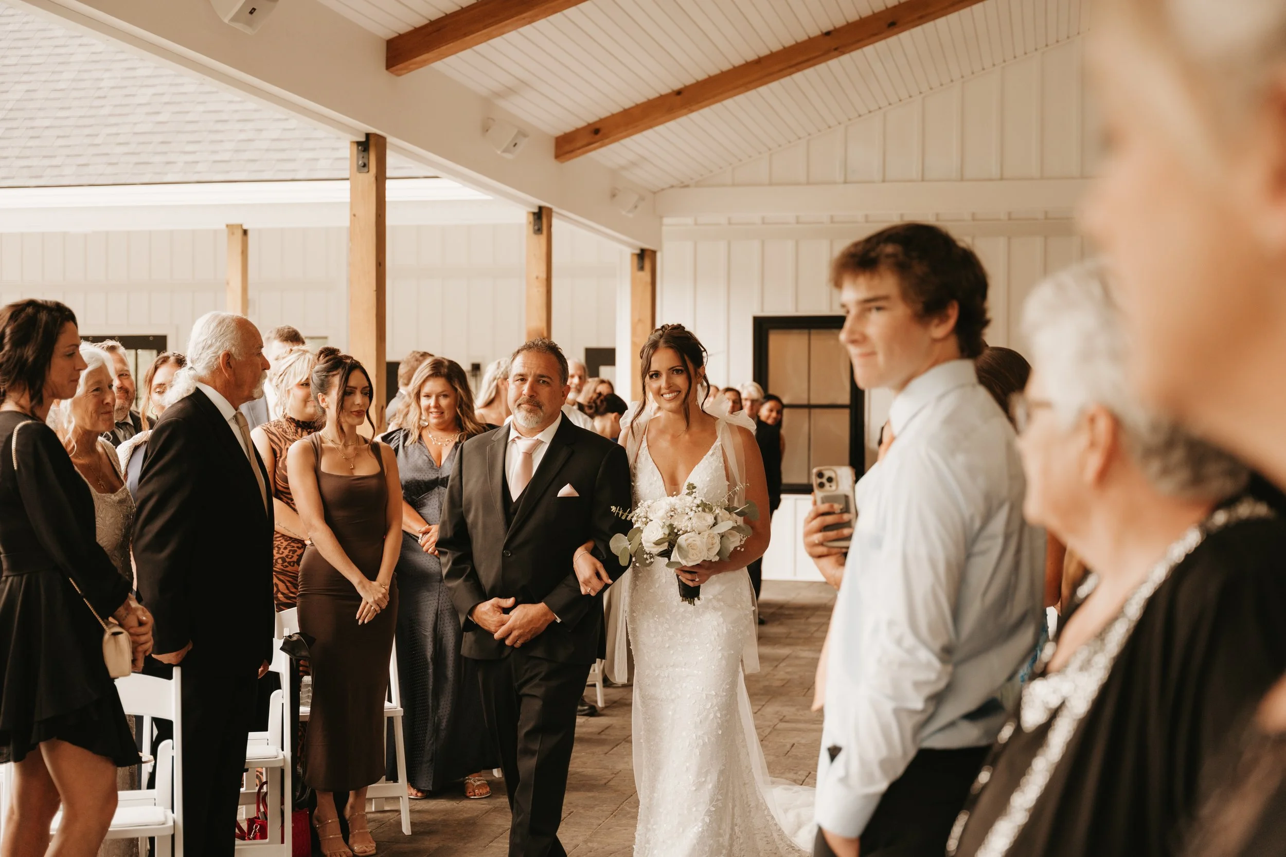 View of processional during wedding ceremony located under the Long Covered Porch. 