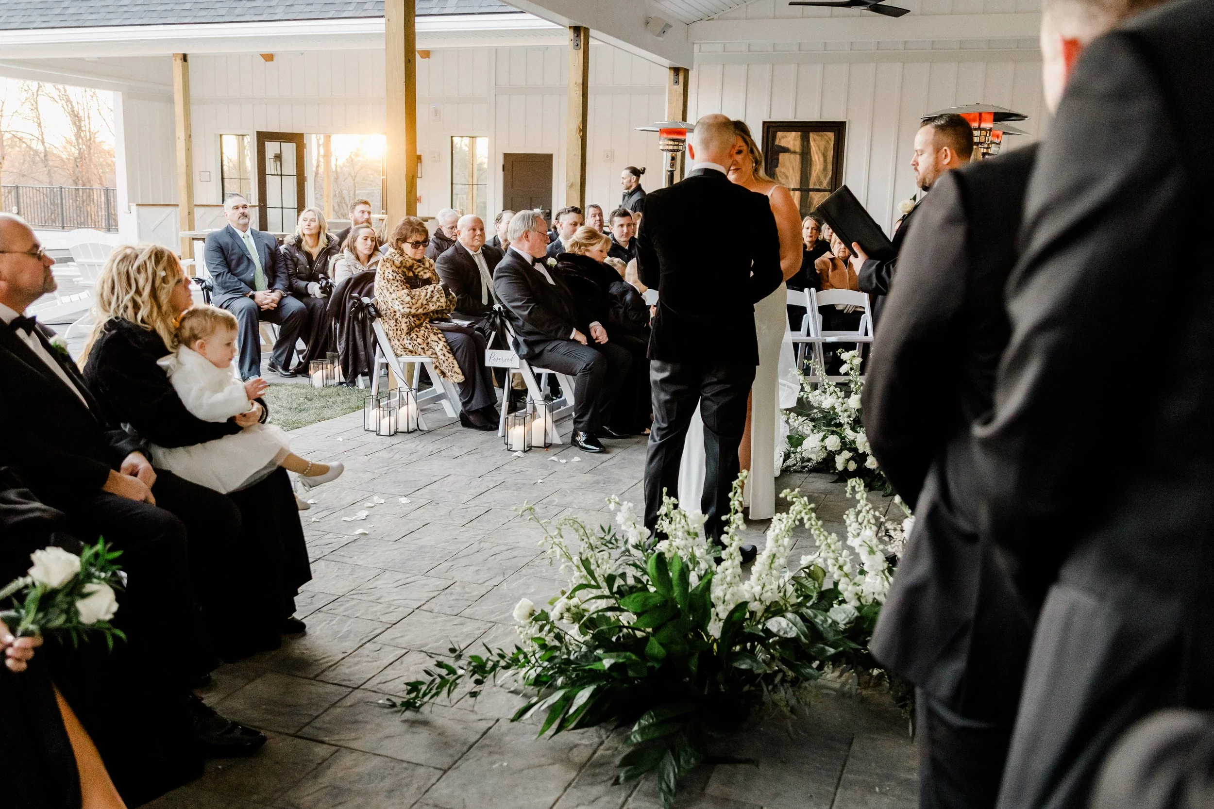 View from wedding party of ceremony under the Long Covered Porch facing guests. 