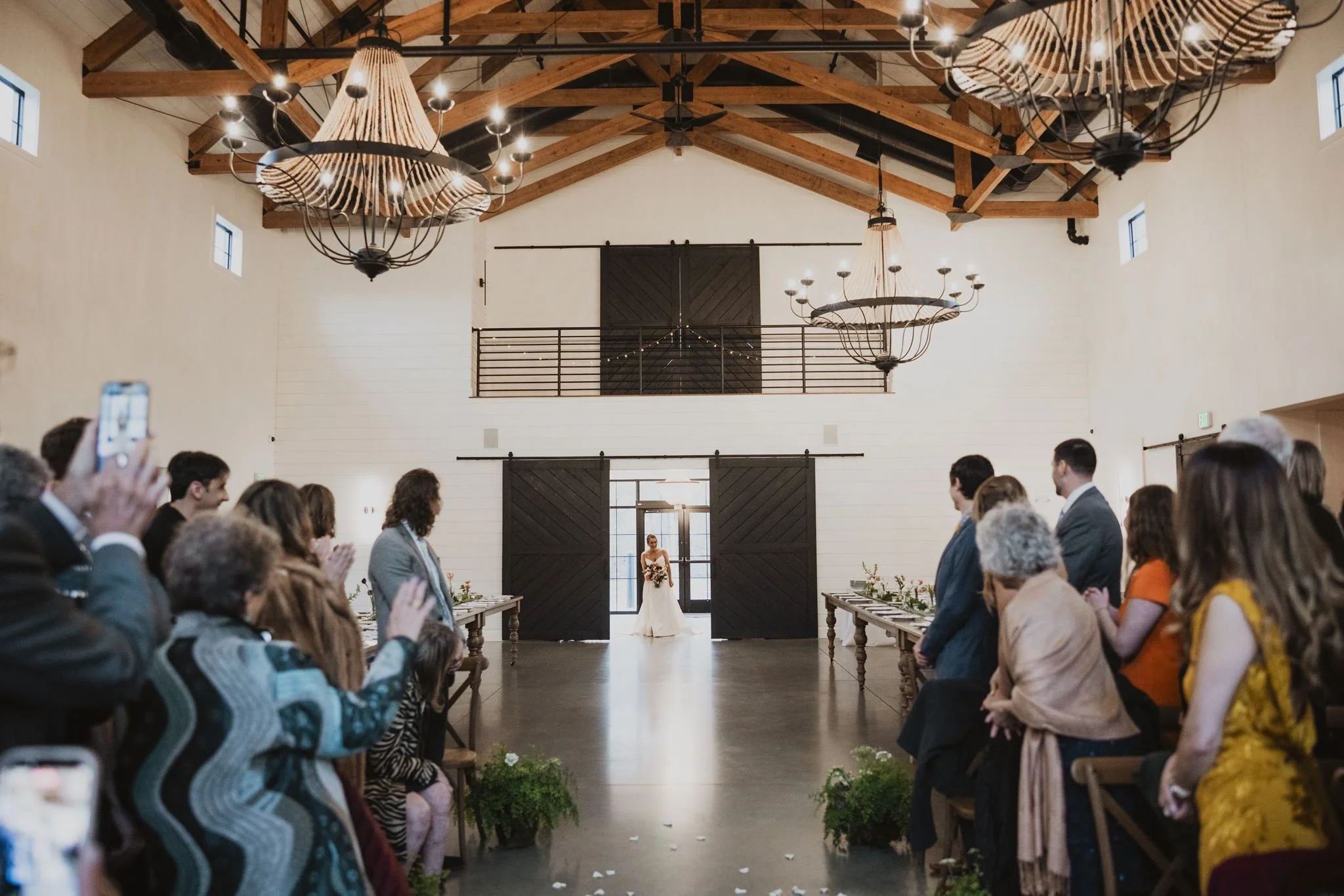 View from guest seating of bride entering our great room from the lobby using our barn doors.