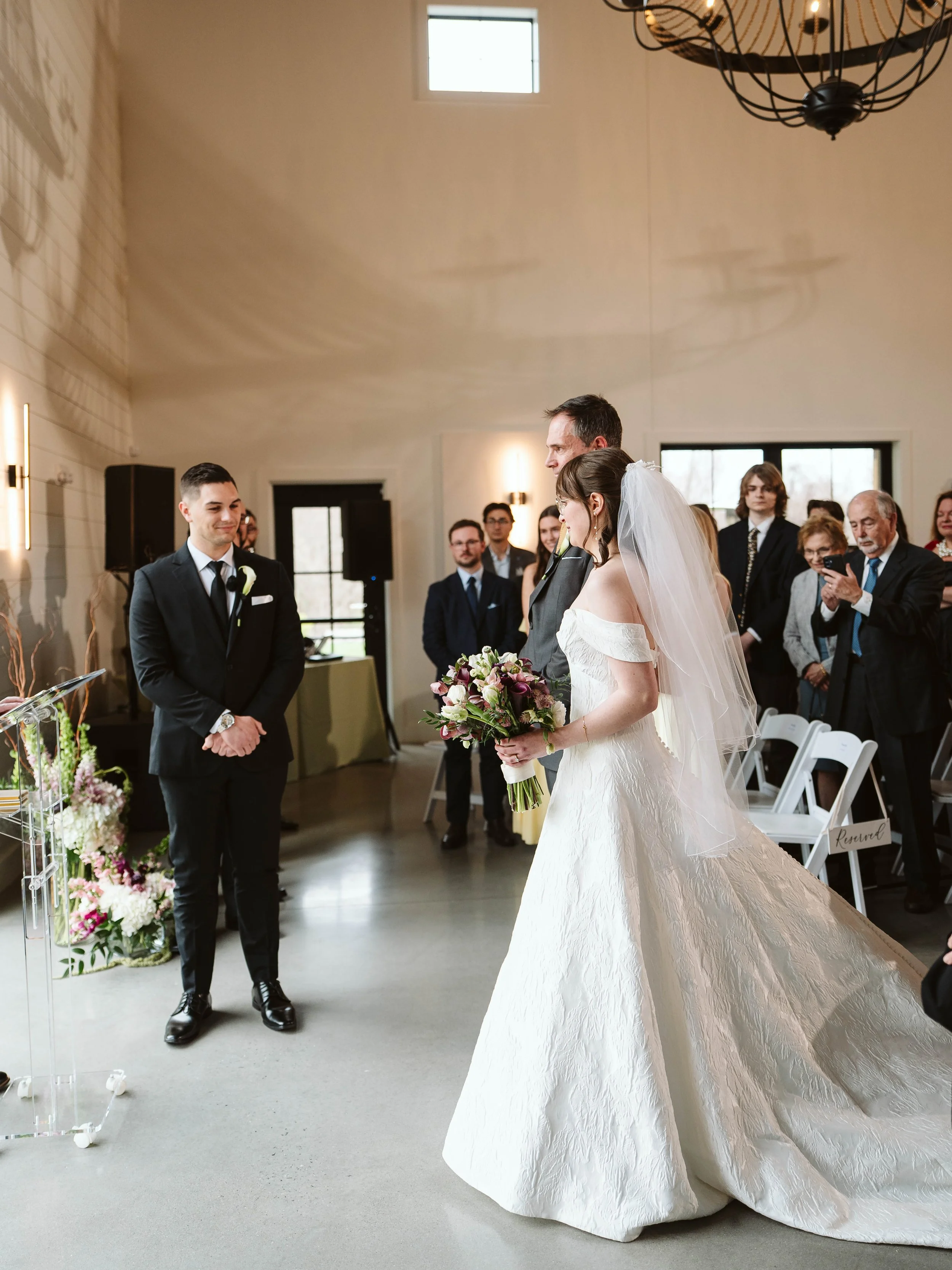 Bride meeting the groom at the end of the aisle.