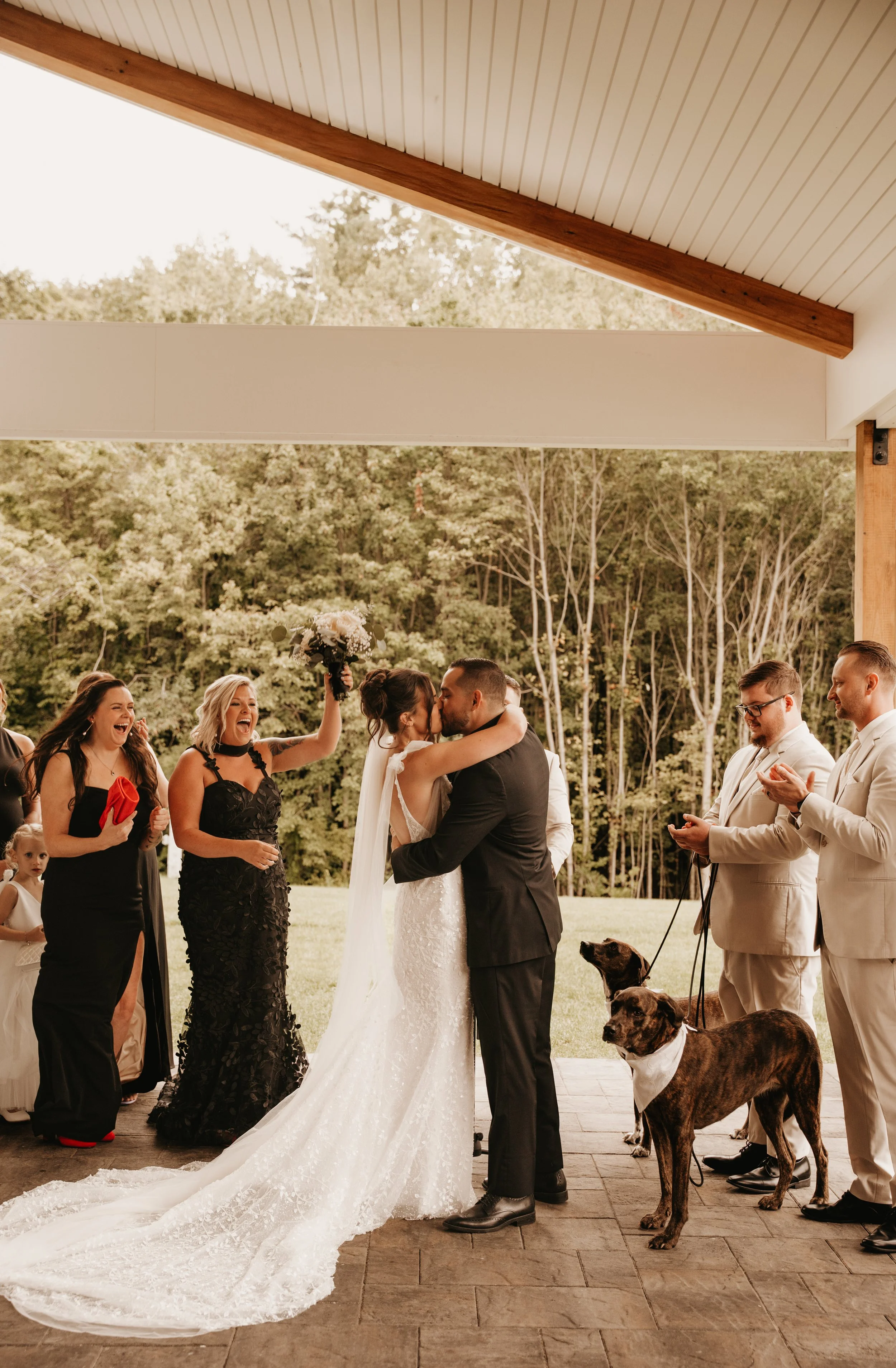 End of wedding ceremony located under the Long Covered Porch facing the back woods. 