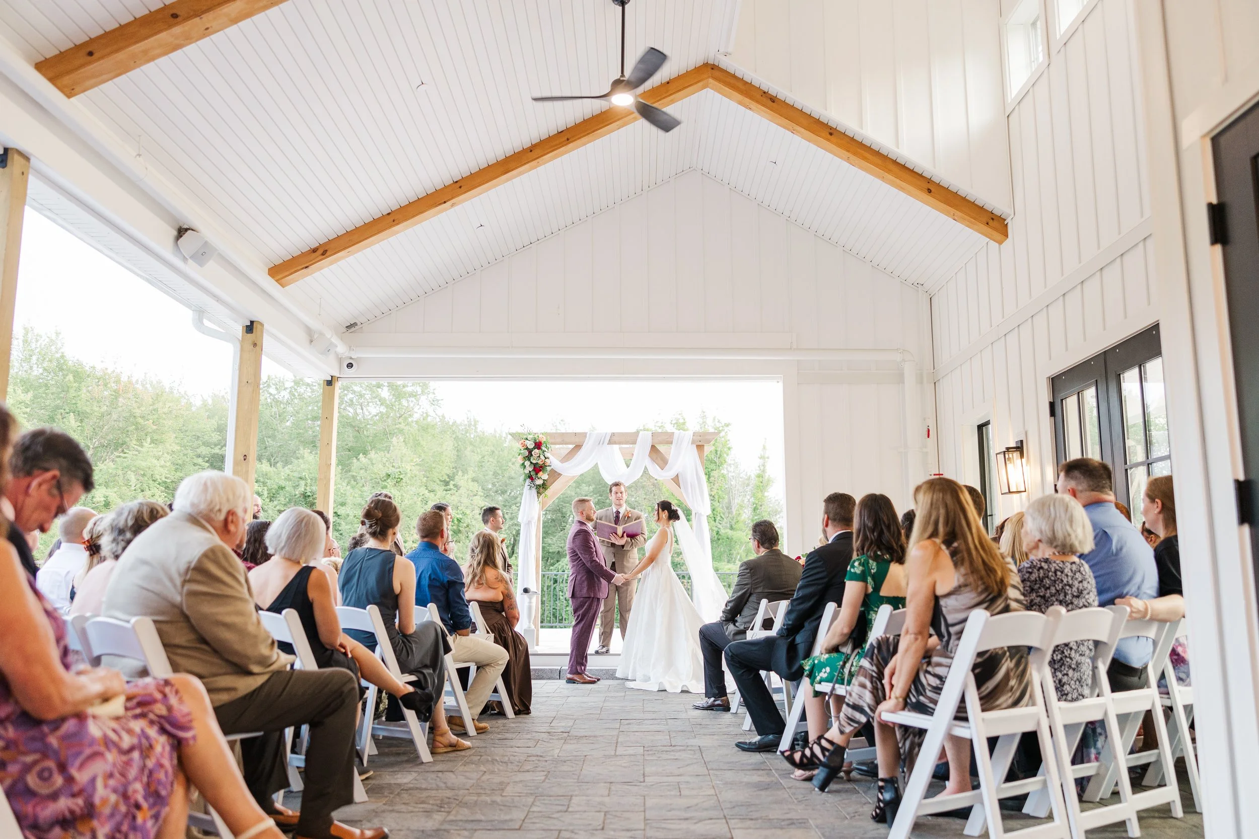 Wedding ceremony located under the Covered Breezeway, view from back guest seating. 