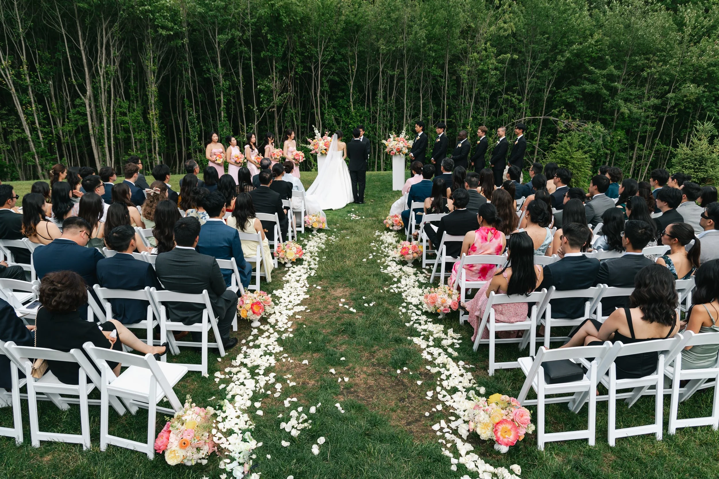 View of wedding ceremony located on the Middle Lawn from the back seating area.