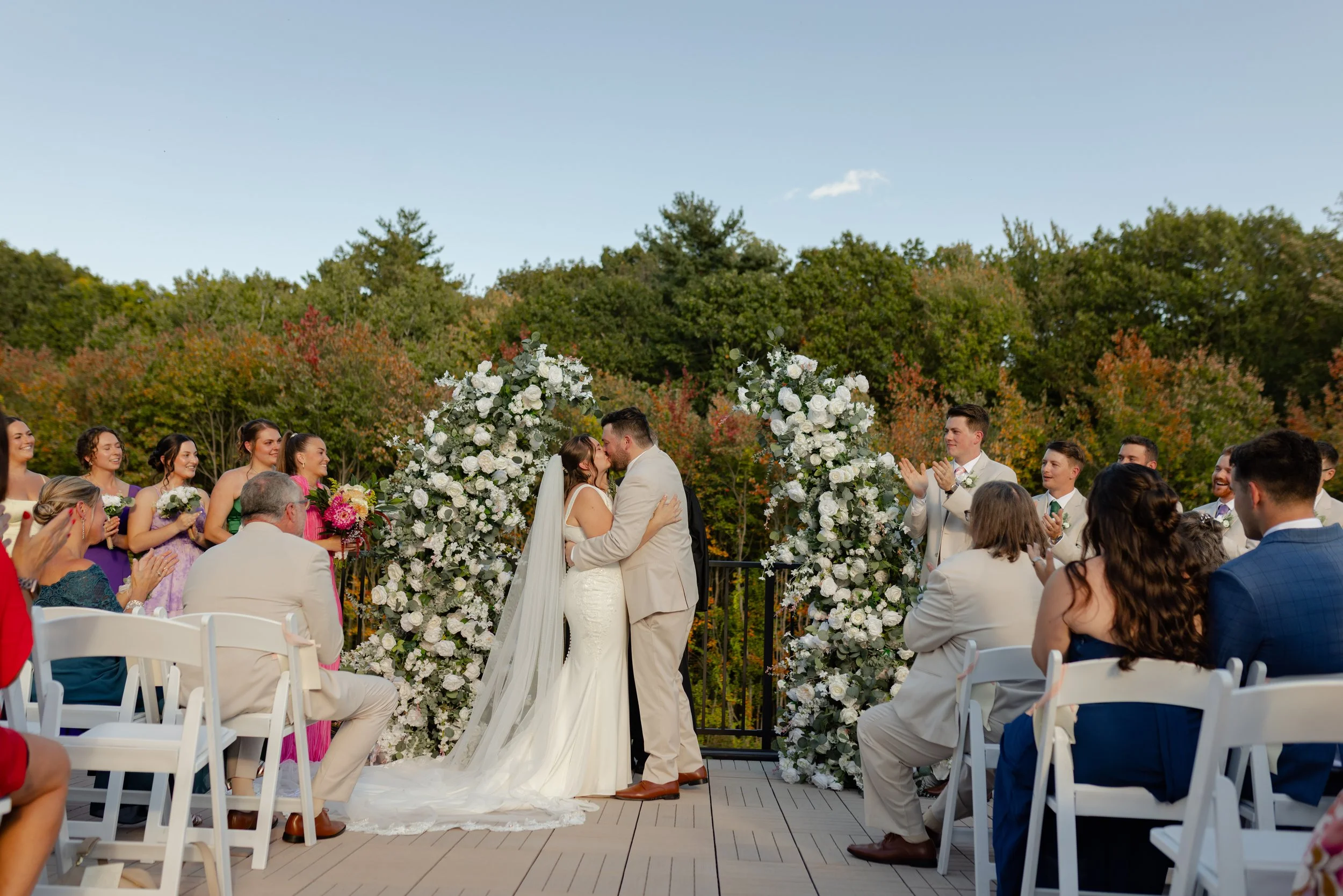 Wedding ceremony located on the Roof Top Deck facing the back woods in late September. 