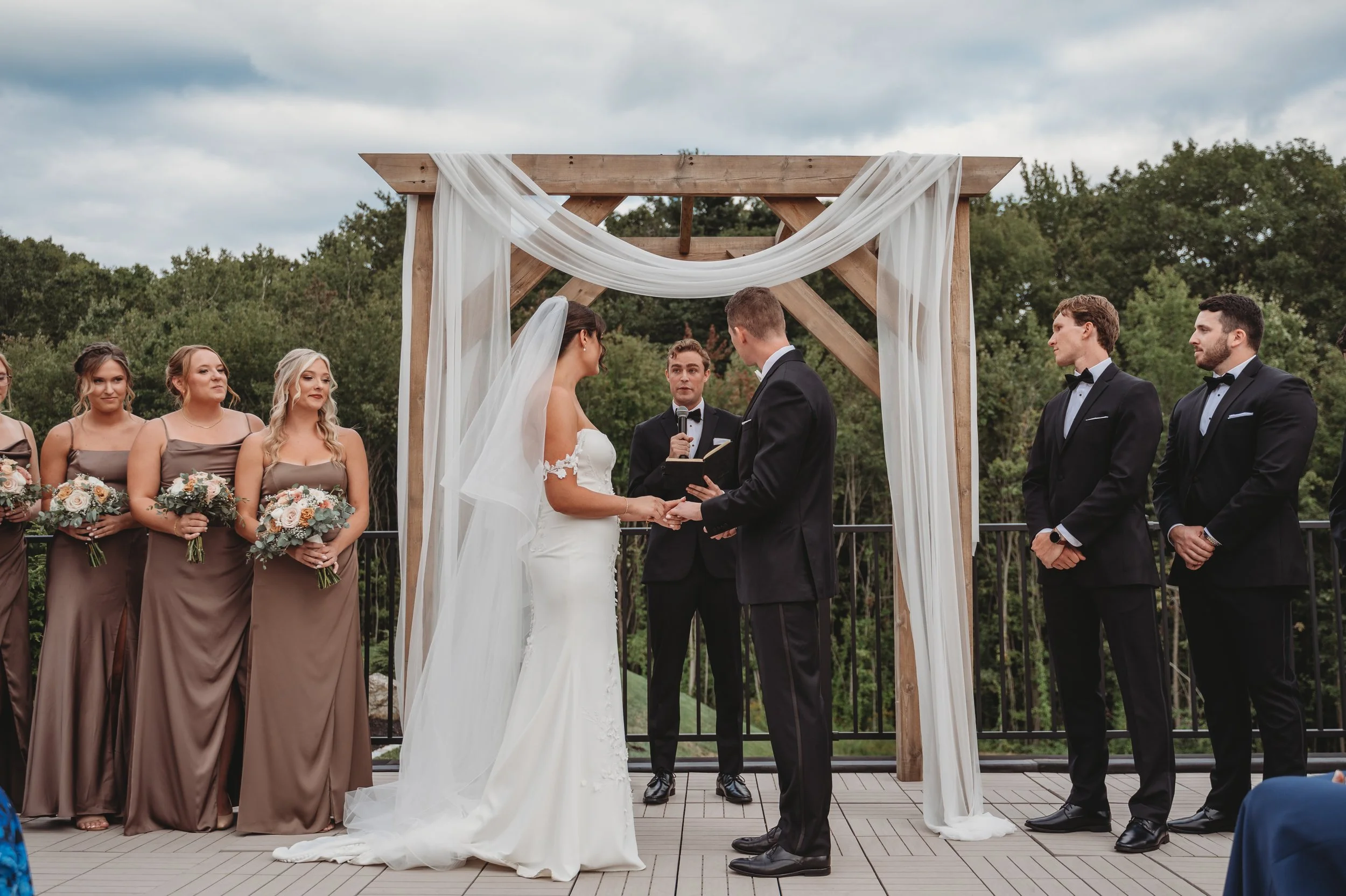 Wedding ceremony located on the Roof Top Deck, guests facing the back woods. 
