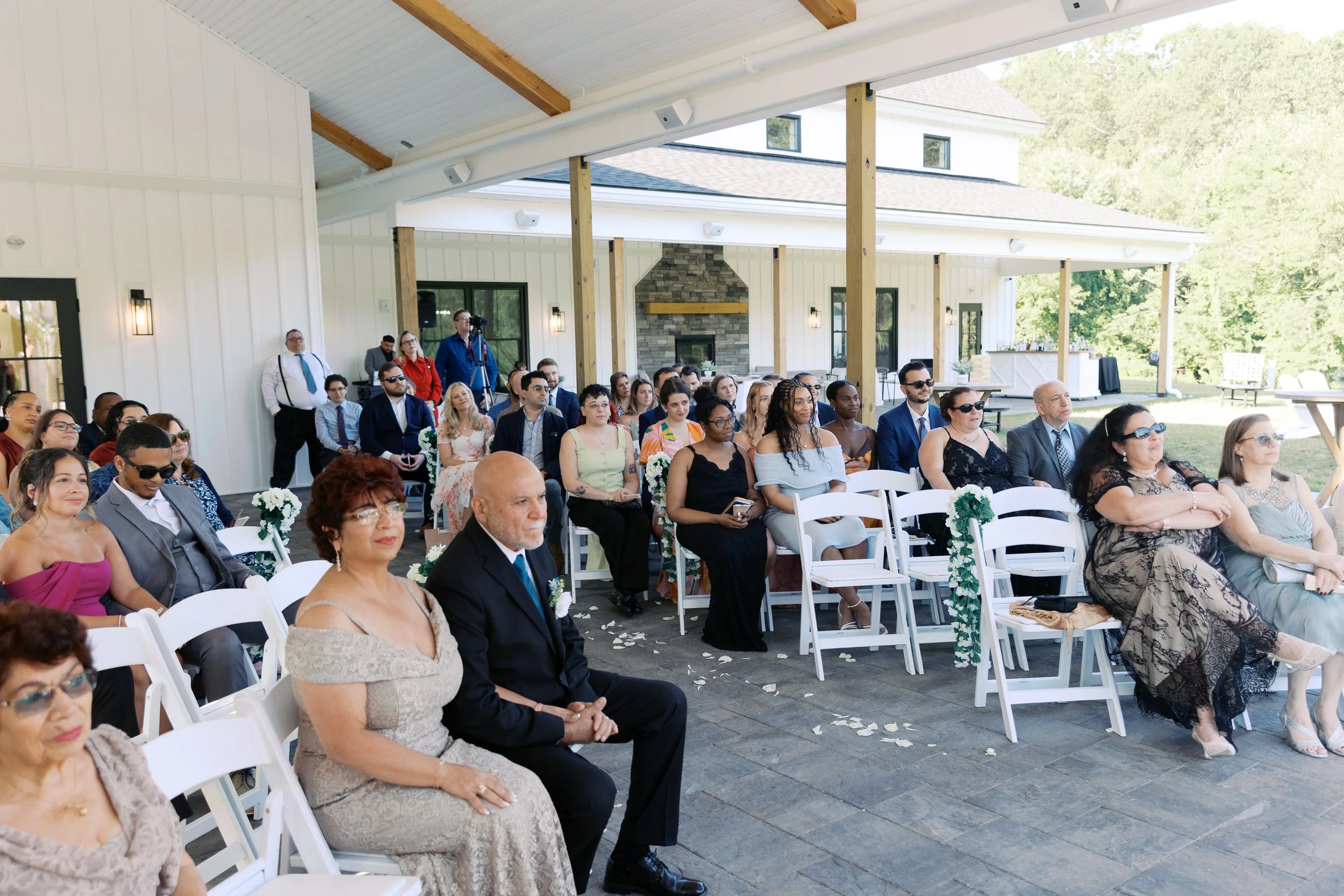 Wedding ceremony located under the Covered Breezeway with guests facing the Roof Top Deck and pond. 