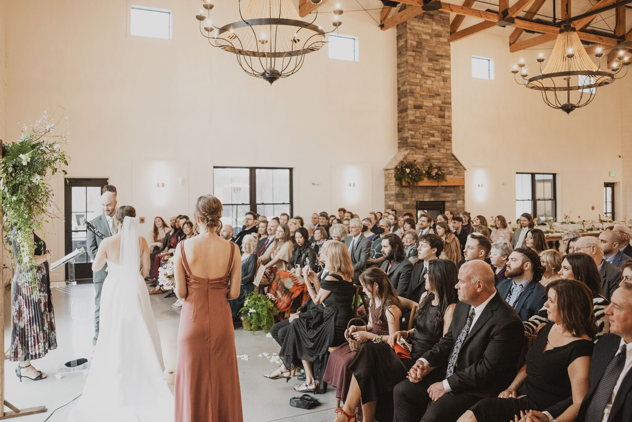 Left side view of couple in front of their guests. 