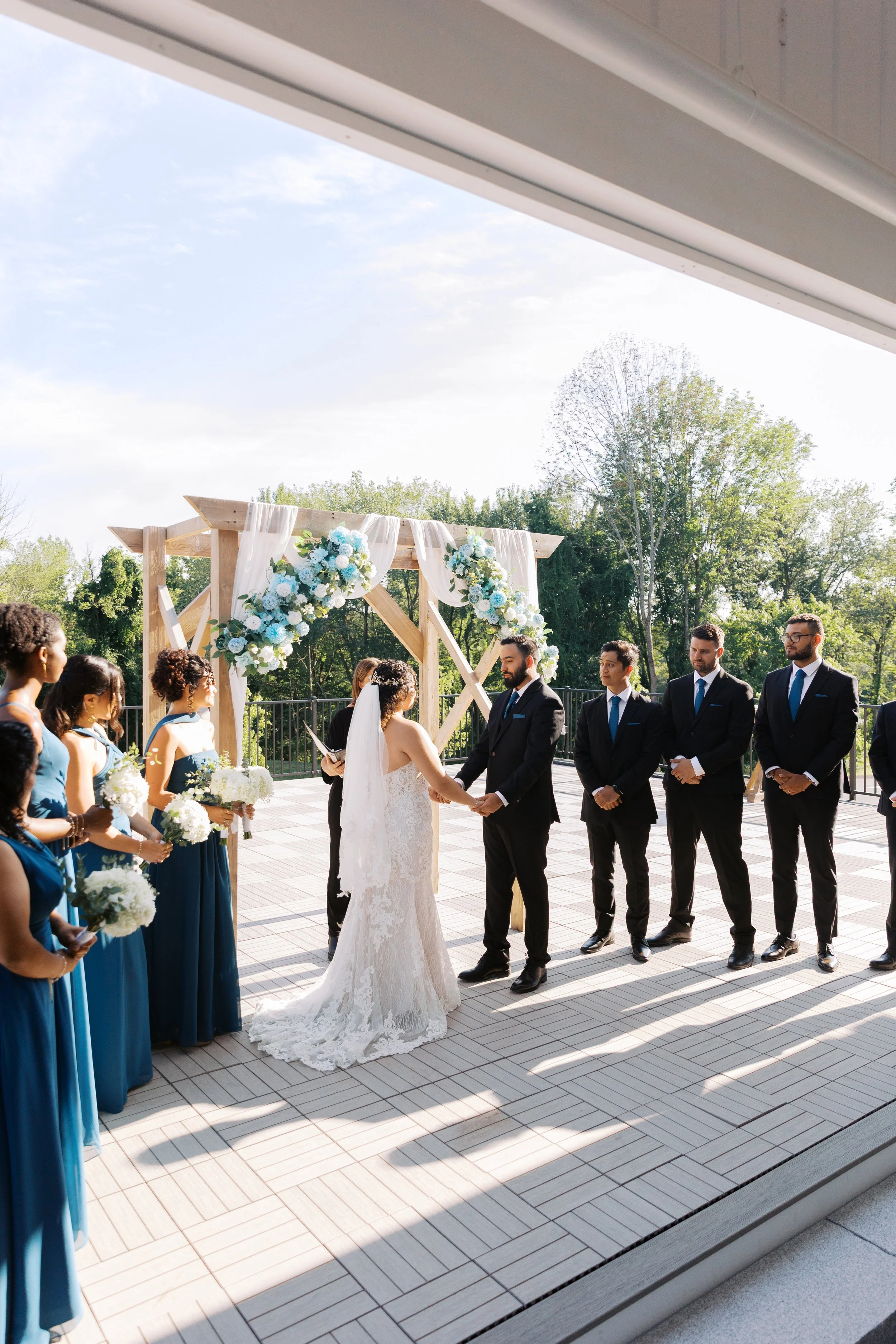 Wedding ceremony with guest seating located under the Covered Breezeway and arch on the Roof Top Deck. 