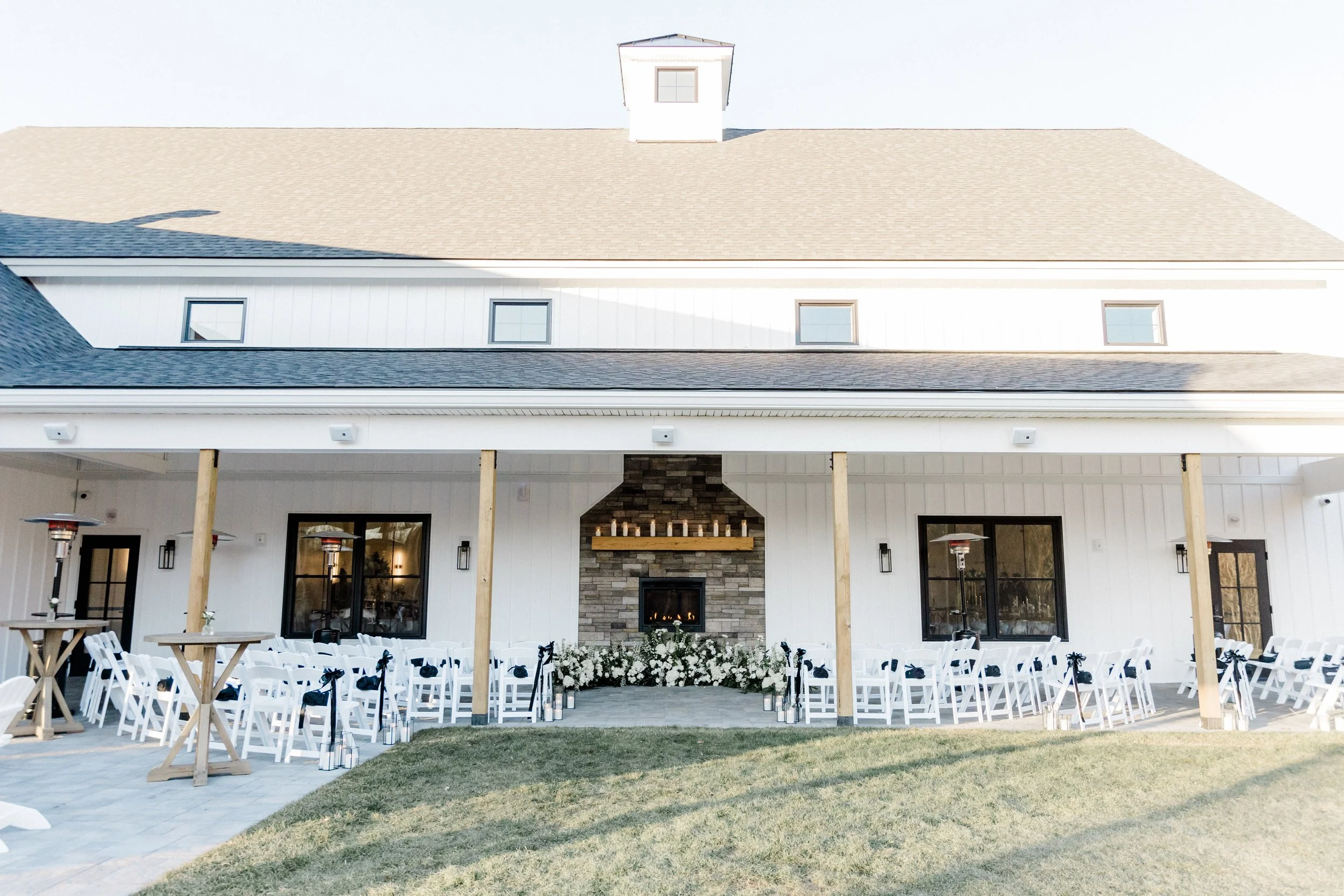 Pre-ceremony view of guest seating under the Long Covered Porch facing the fireplace. 