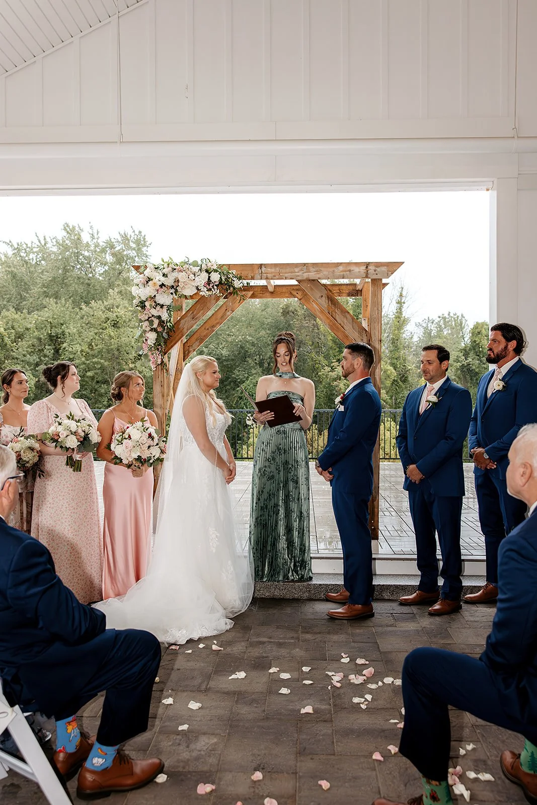 Wedding ceremony located under the Covered Breezeway facing the Roof Top Deck and pond. 