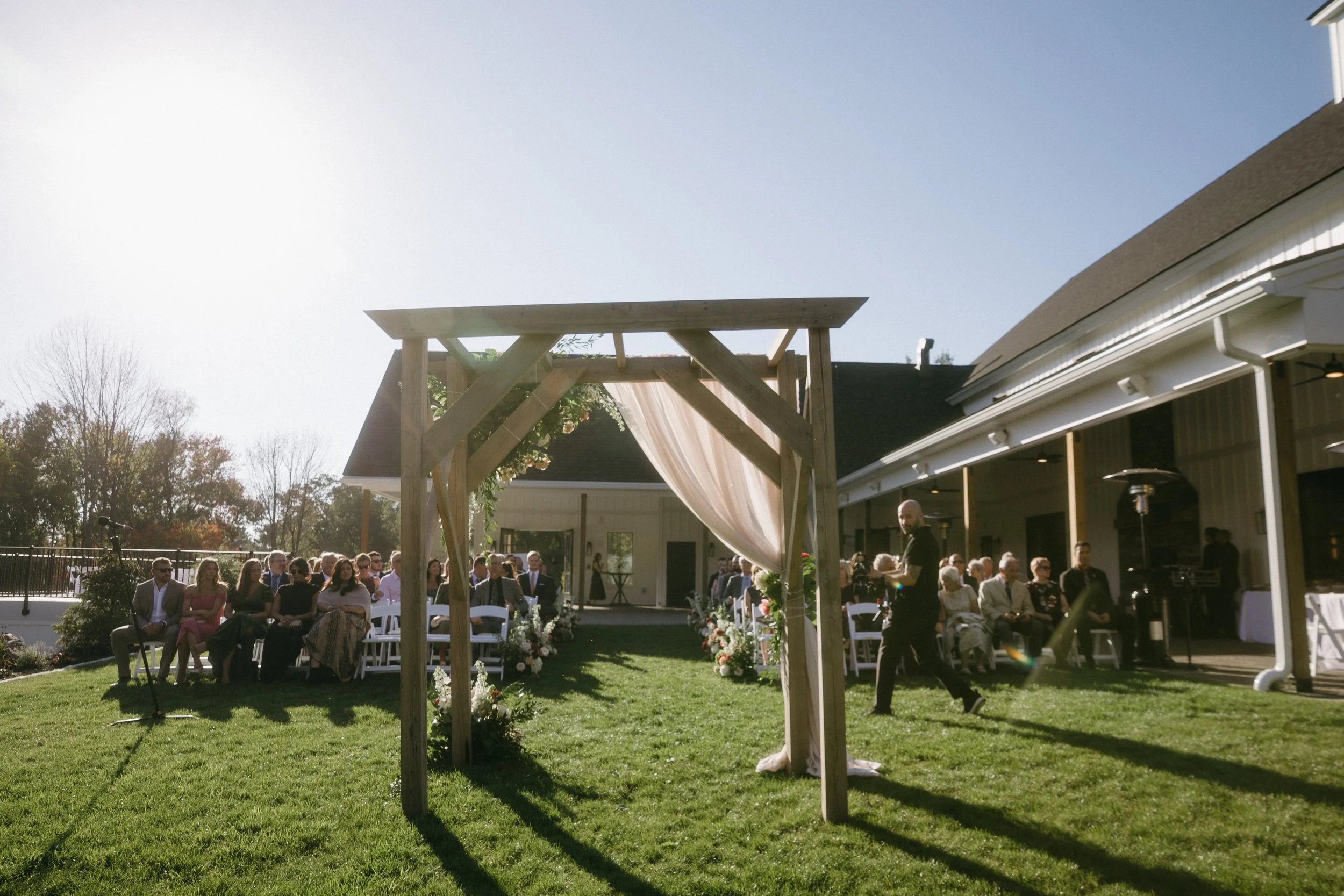 View from behind the arch facing the guests on the Middle Lawn. 