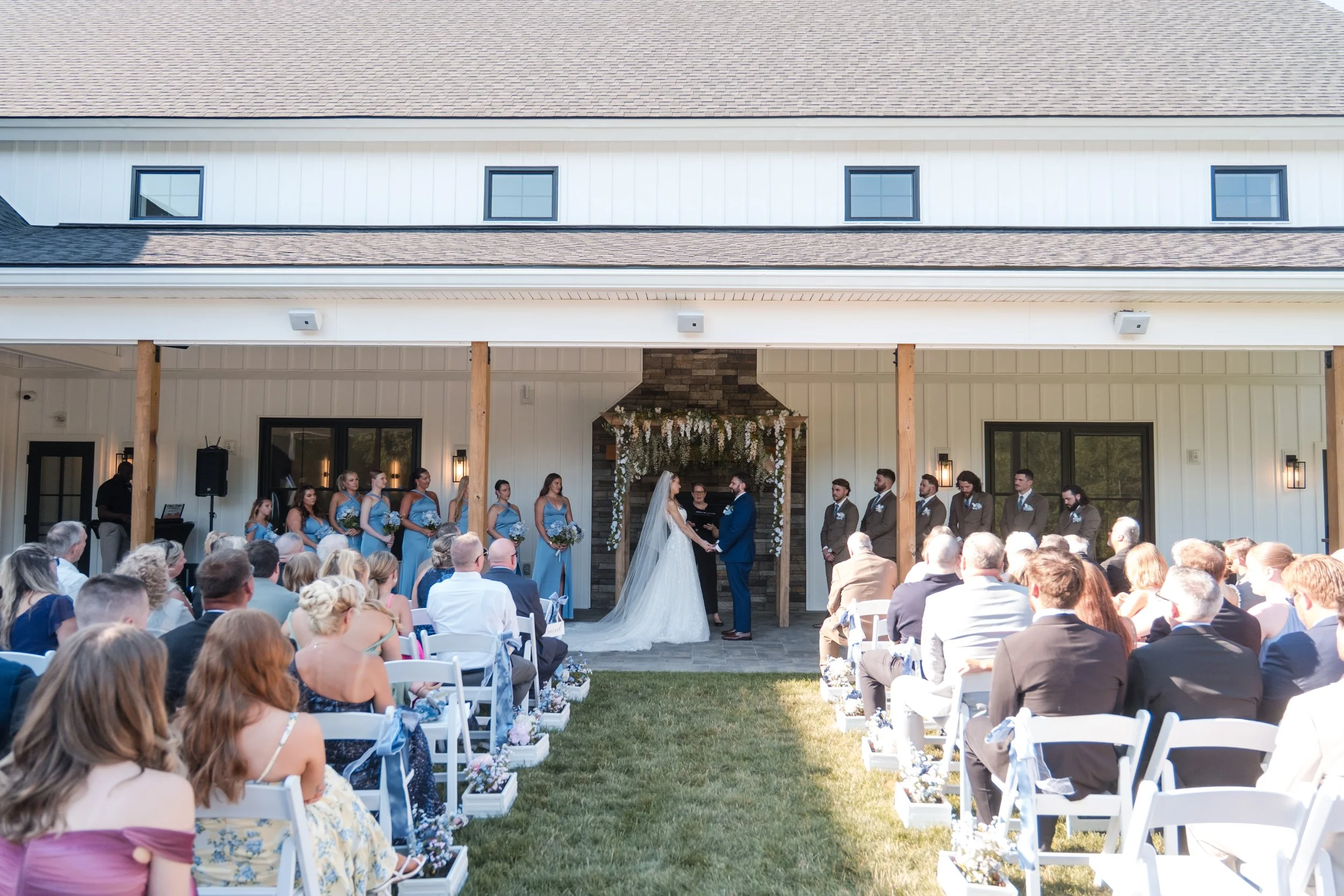 View from the back of guest seating of wedding ceremony facing the fireplace. 