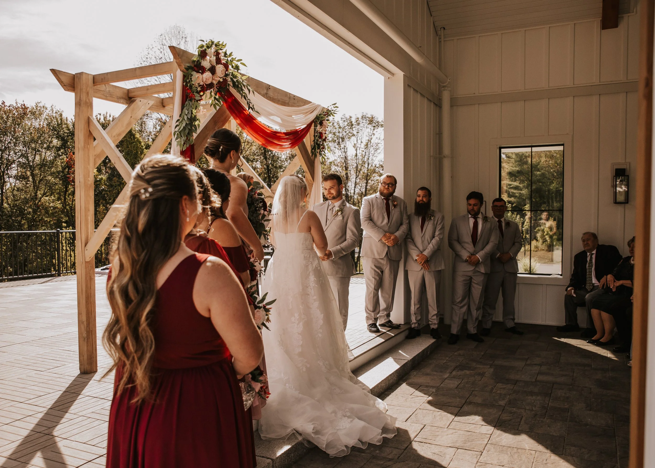 View of a bridesmaid on the left under the covered breezeway.