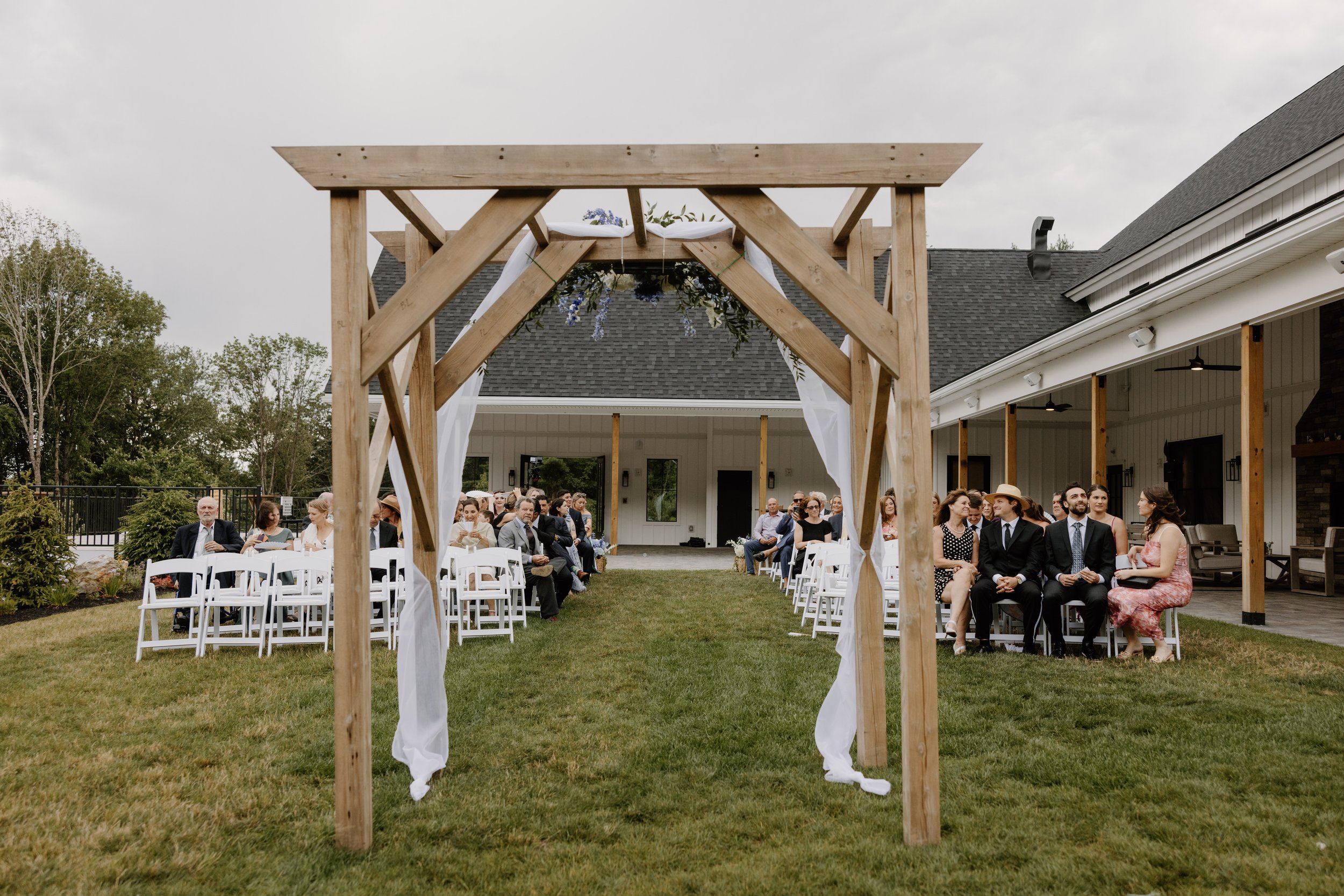 View from behind the arch facing the aisle of Middle Lawn ceremony space. 