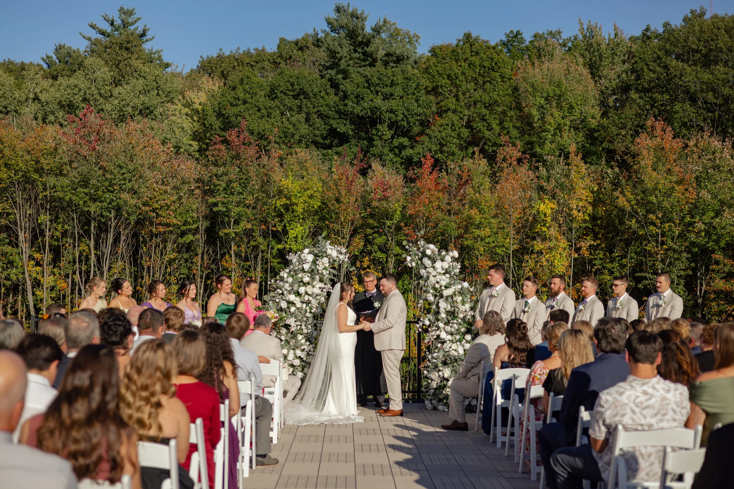 Wedding ceremony located on the Roof Top Deck facing the back woods in late September. 