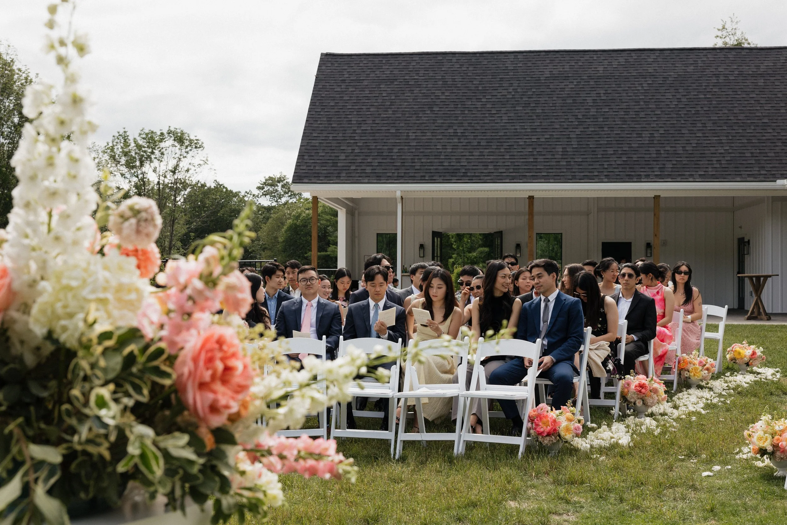 Wedding ceremony located on the Middle Lawn with guests facing the back woods. 