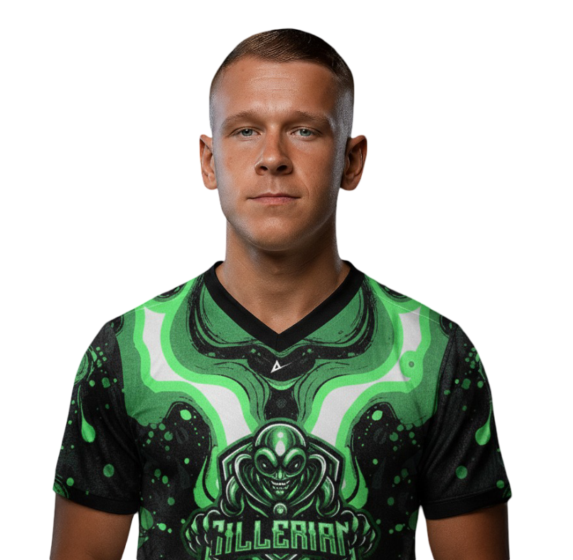 A man with a serious expression wearing a tan jacket with a patch on the arm, a red scarf, and a backpack.