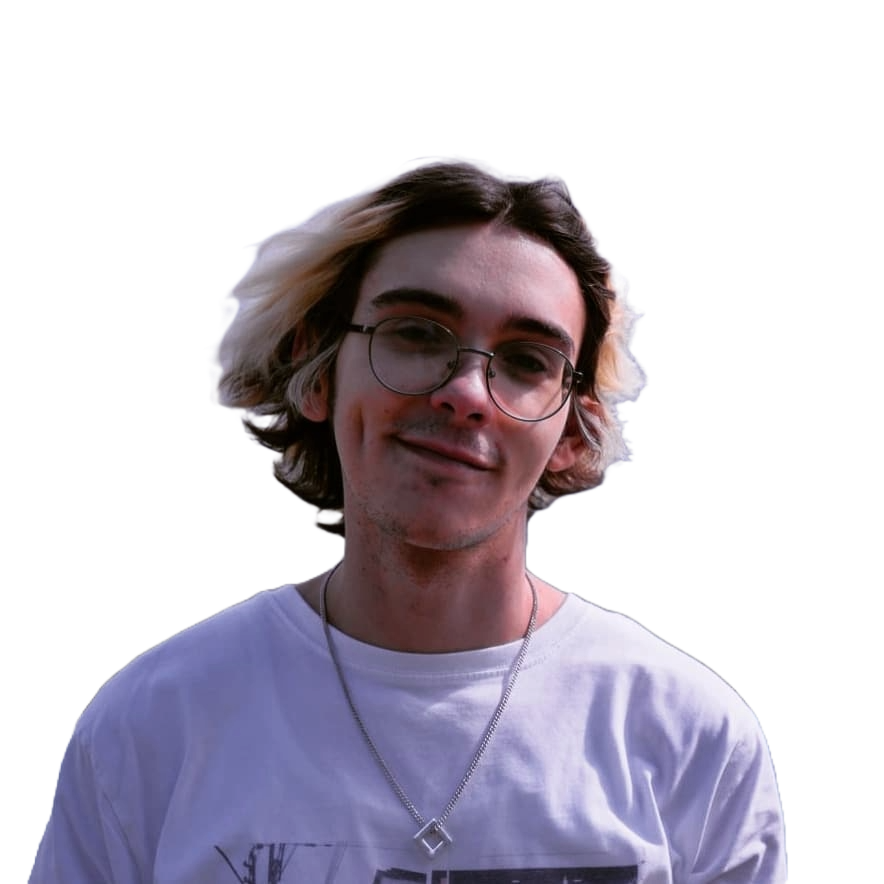 A young man with wavy, two-toned hair wearing glasses and a white t-shirt, smiling at the camera.