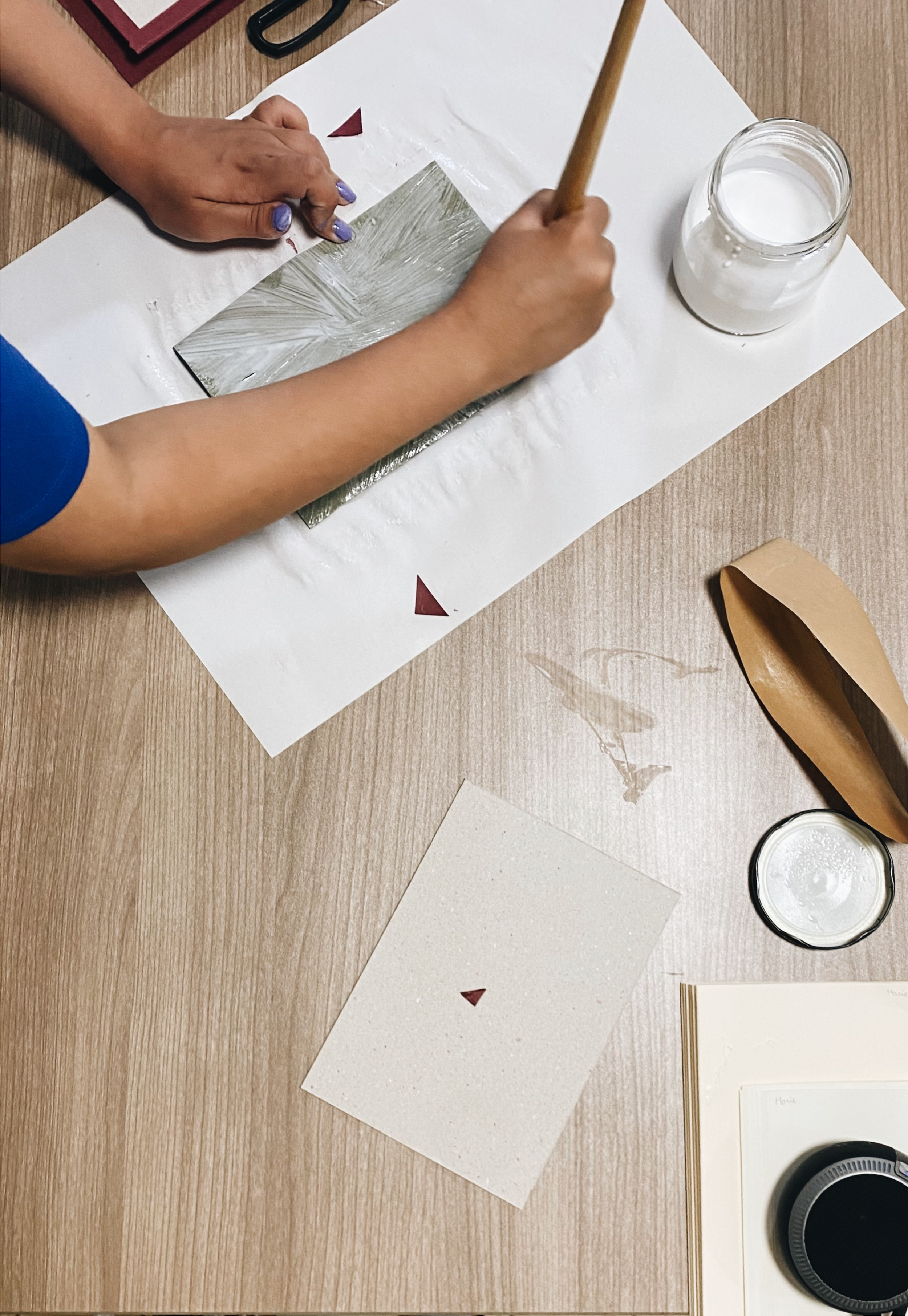 A hand gluing a book hardcover