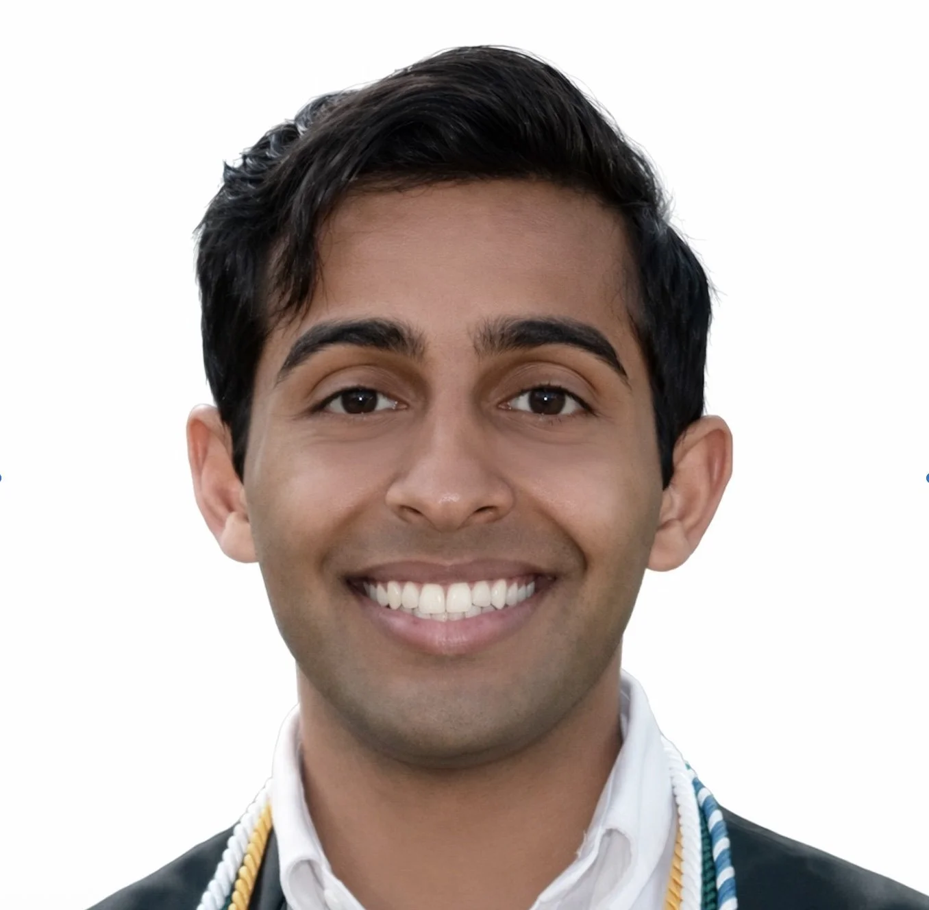 Man smiling in a professional headshot wearing a white and black shirt against a plain white background.