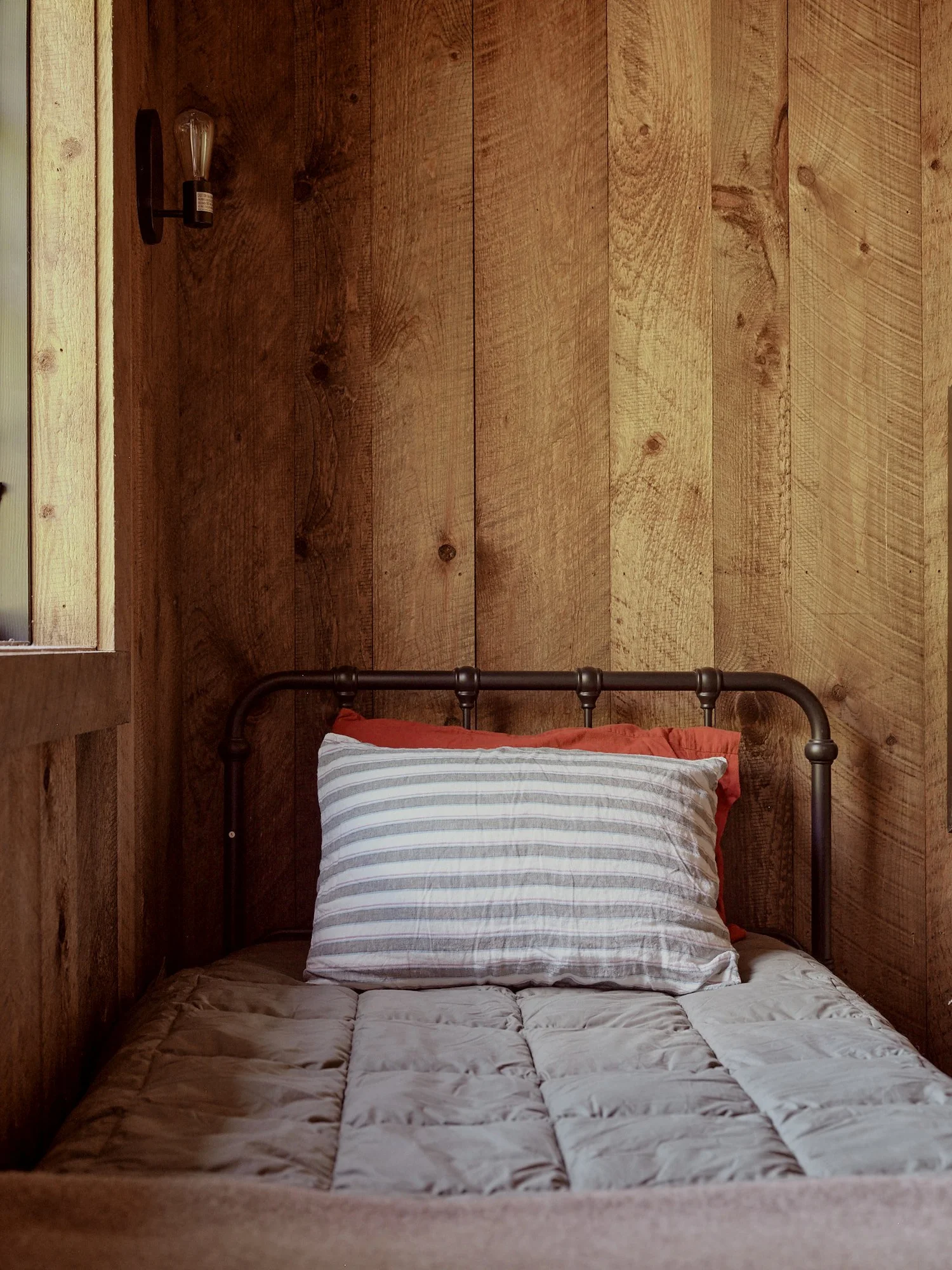 Twin bed with a striped pillow