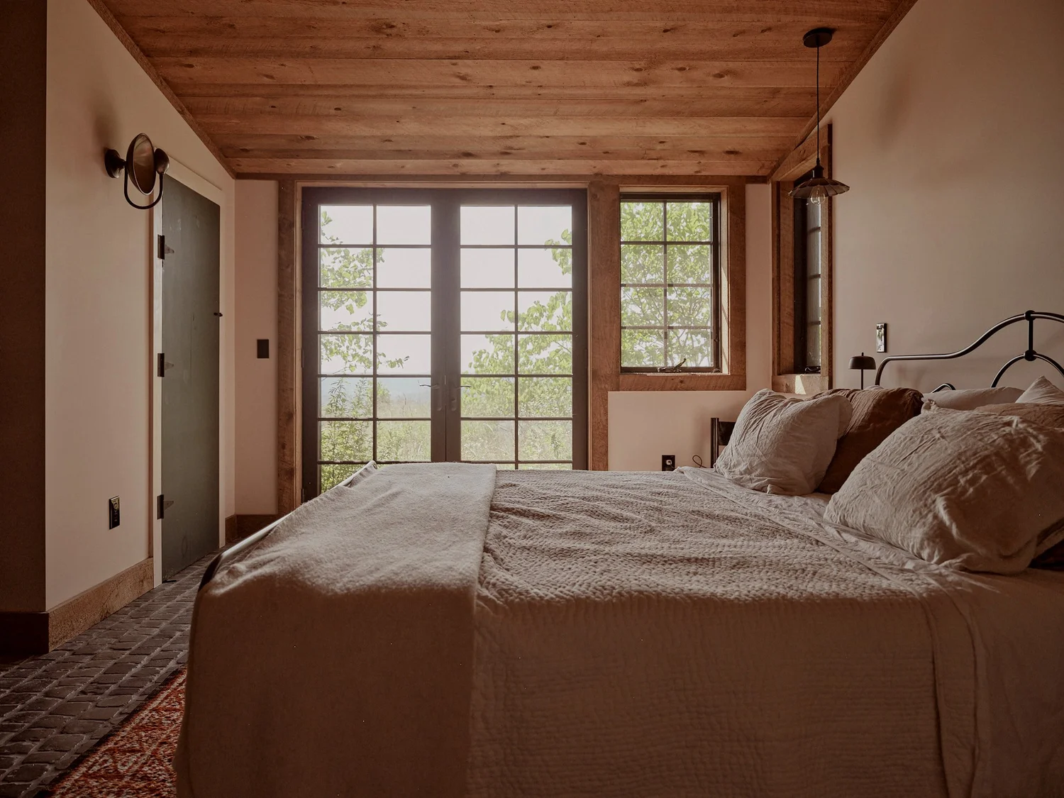 A bedroom with morning light across the bed