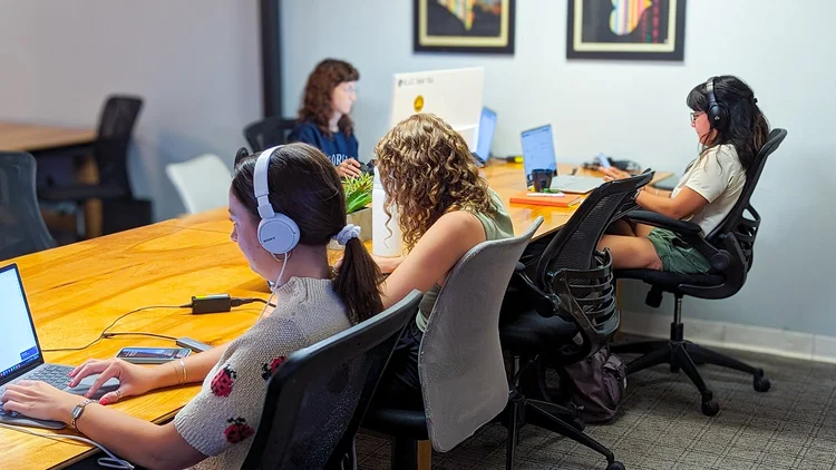 People collaborating around a table at Createscape coworking.