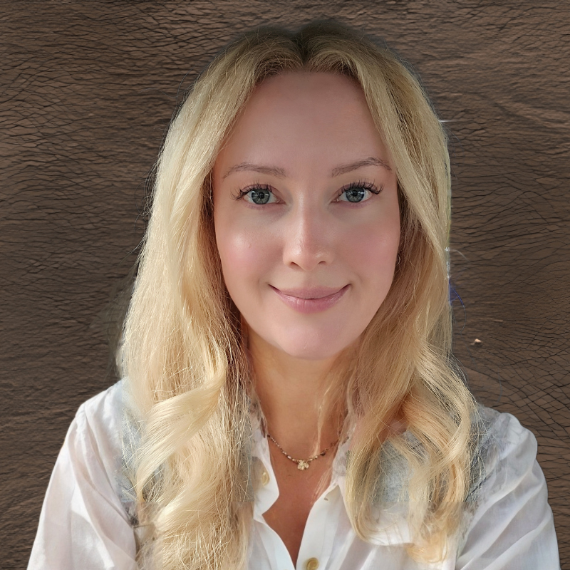 Ana Mourant, a white person with long blonde hair wearing a white blouse.