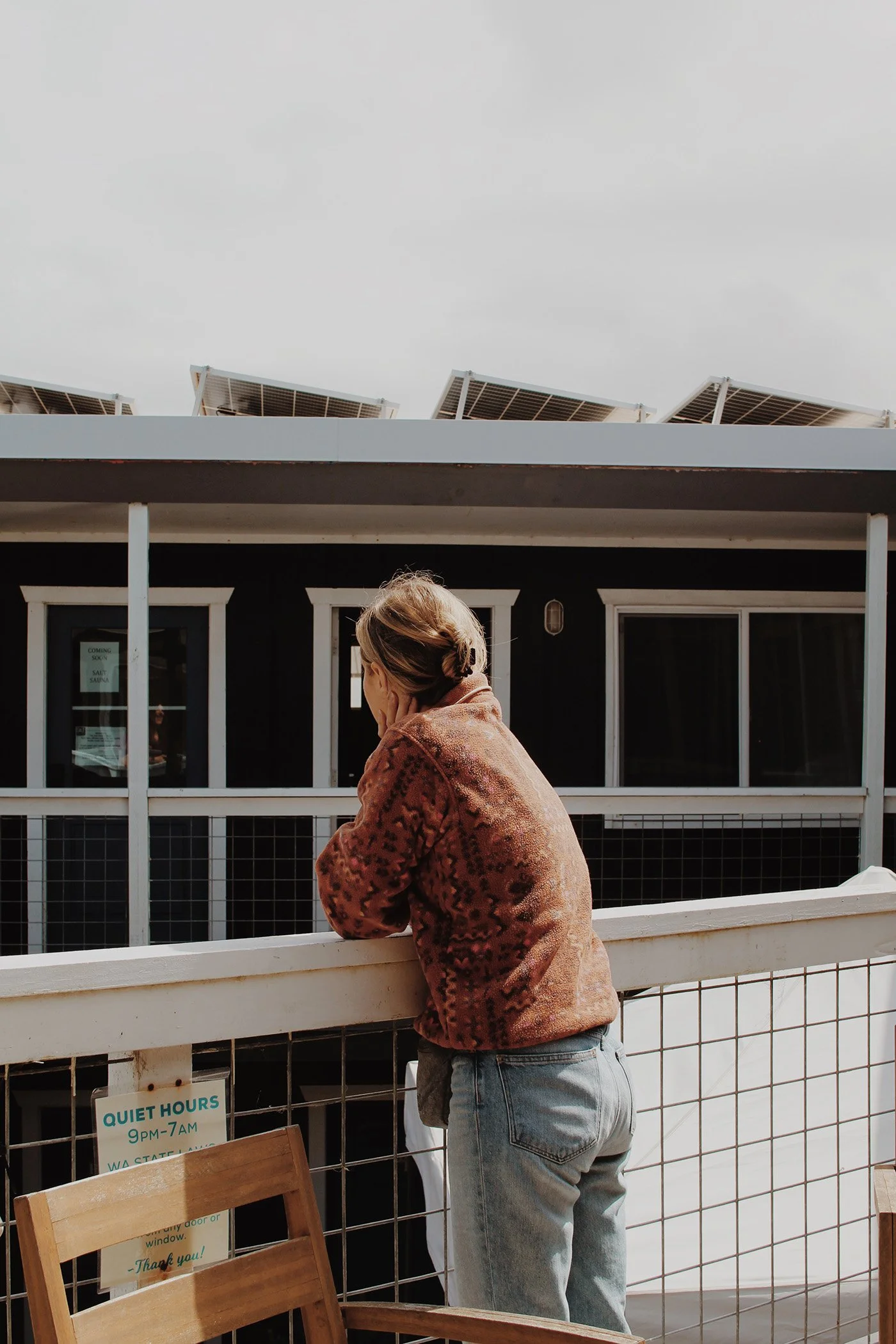 woman looking out from balcony