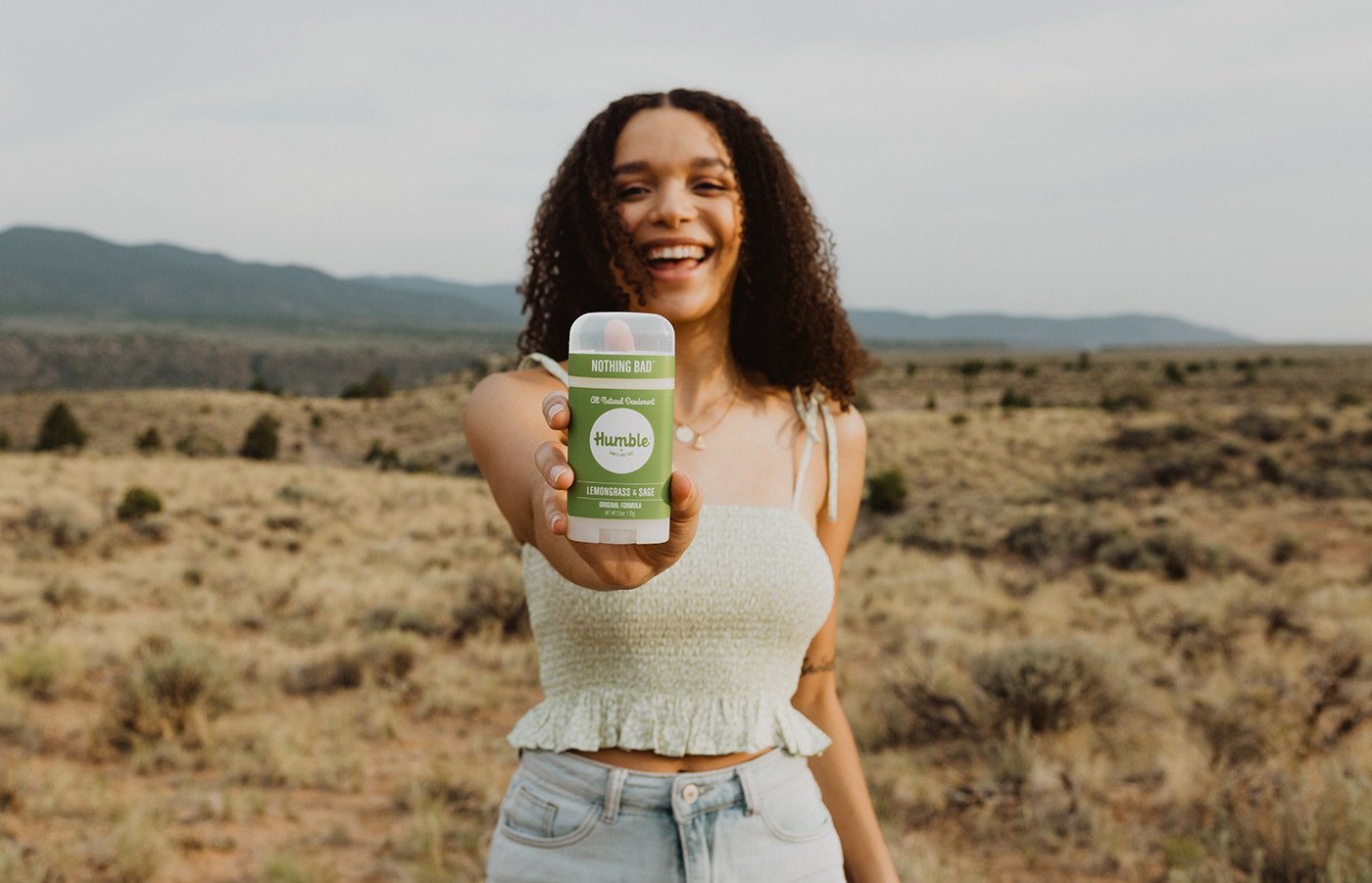 Woman holding Lemongrass & Sage deodorant