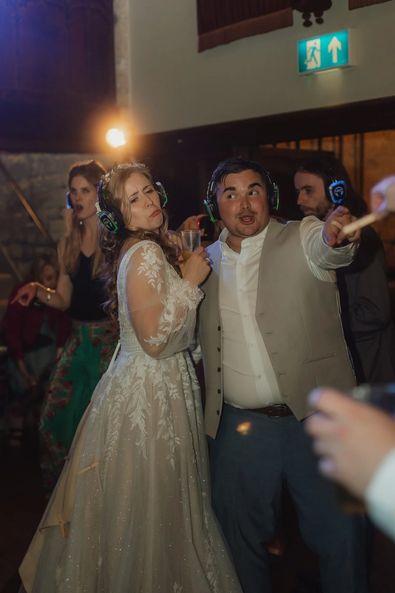 Guests dancing on a busy wedding dancefloor at night