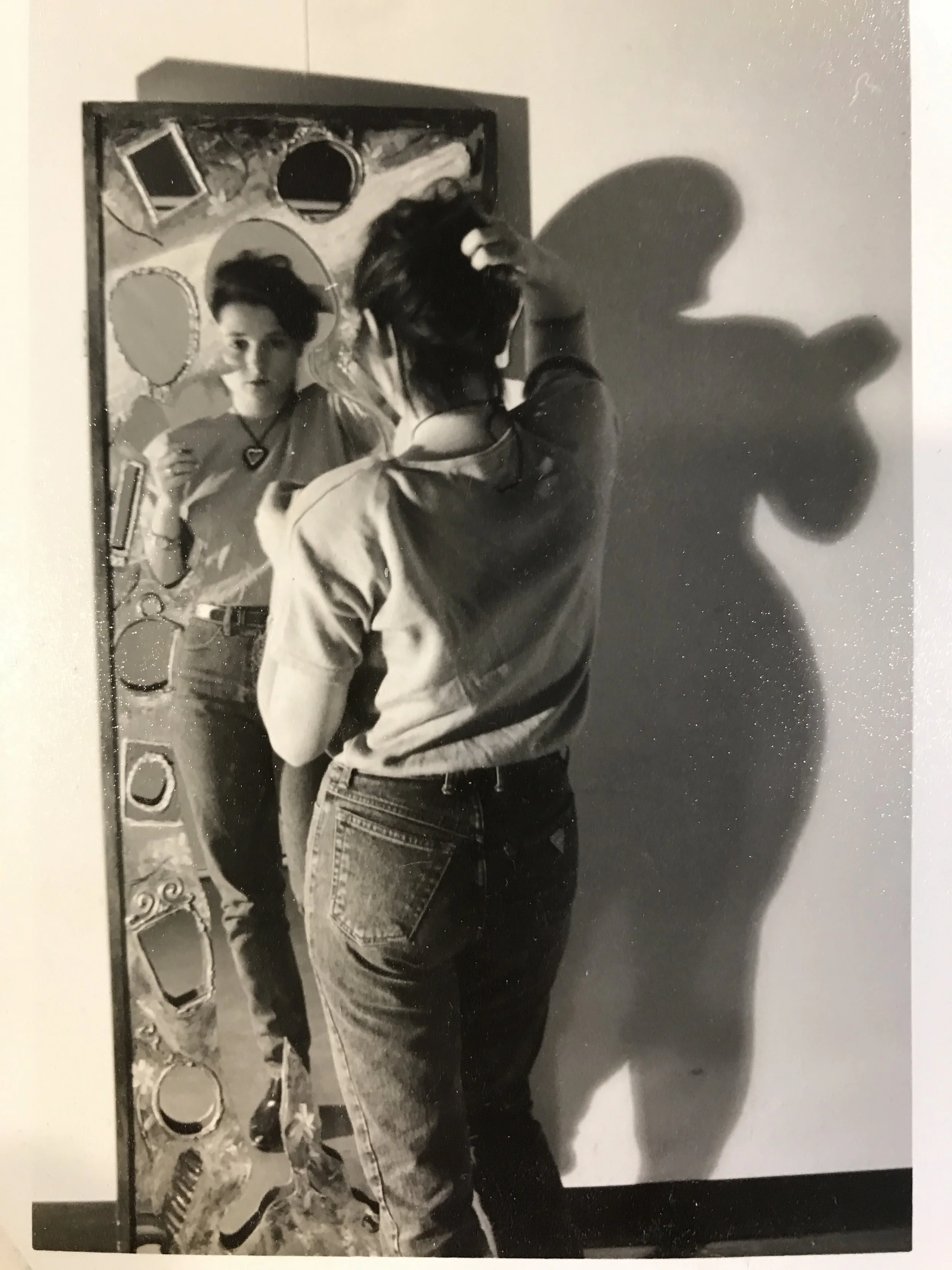 Me in graduate school at Texas Teach with funky art mirror Ii made.