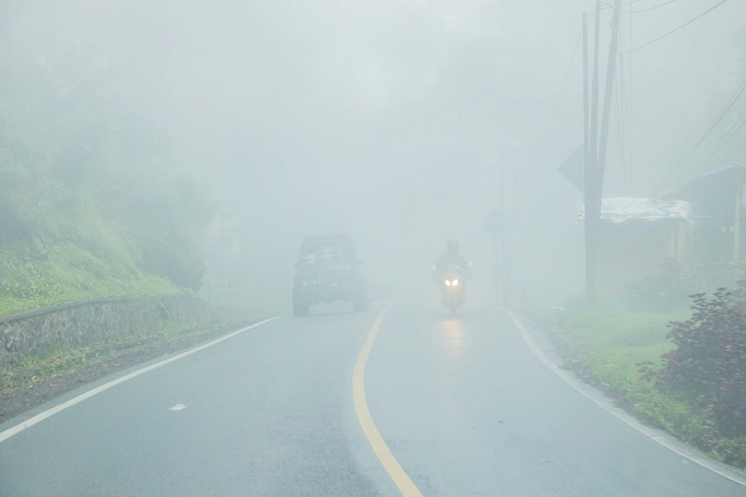 Driving through the misty hills towards Ciwidey